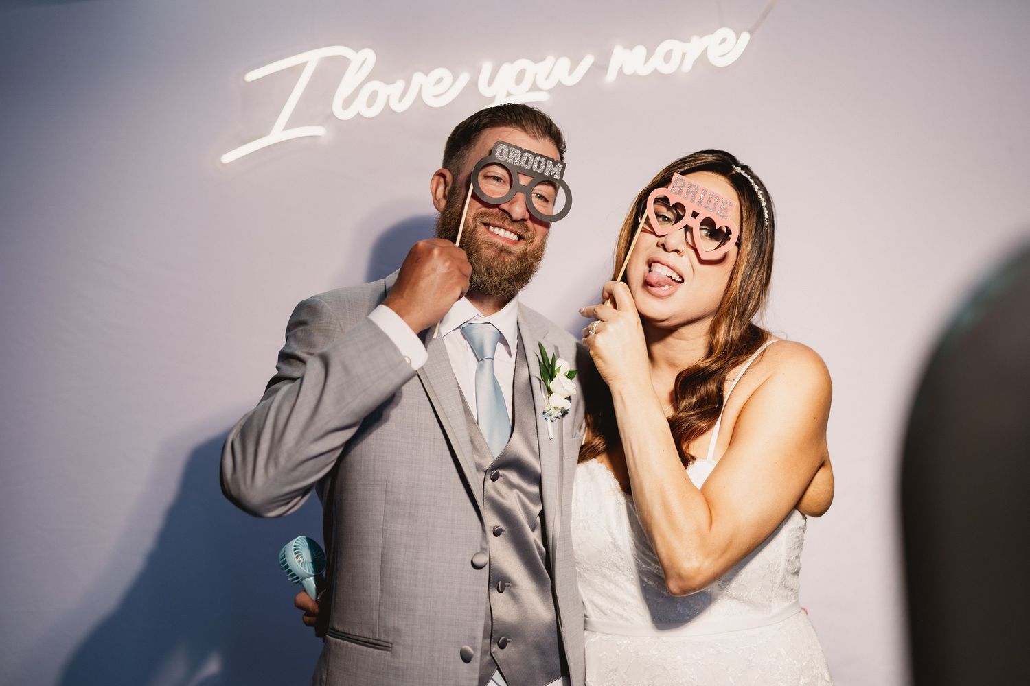 A series of seven black and white wedding photos showing joyful moments between a couple in formal attire.