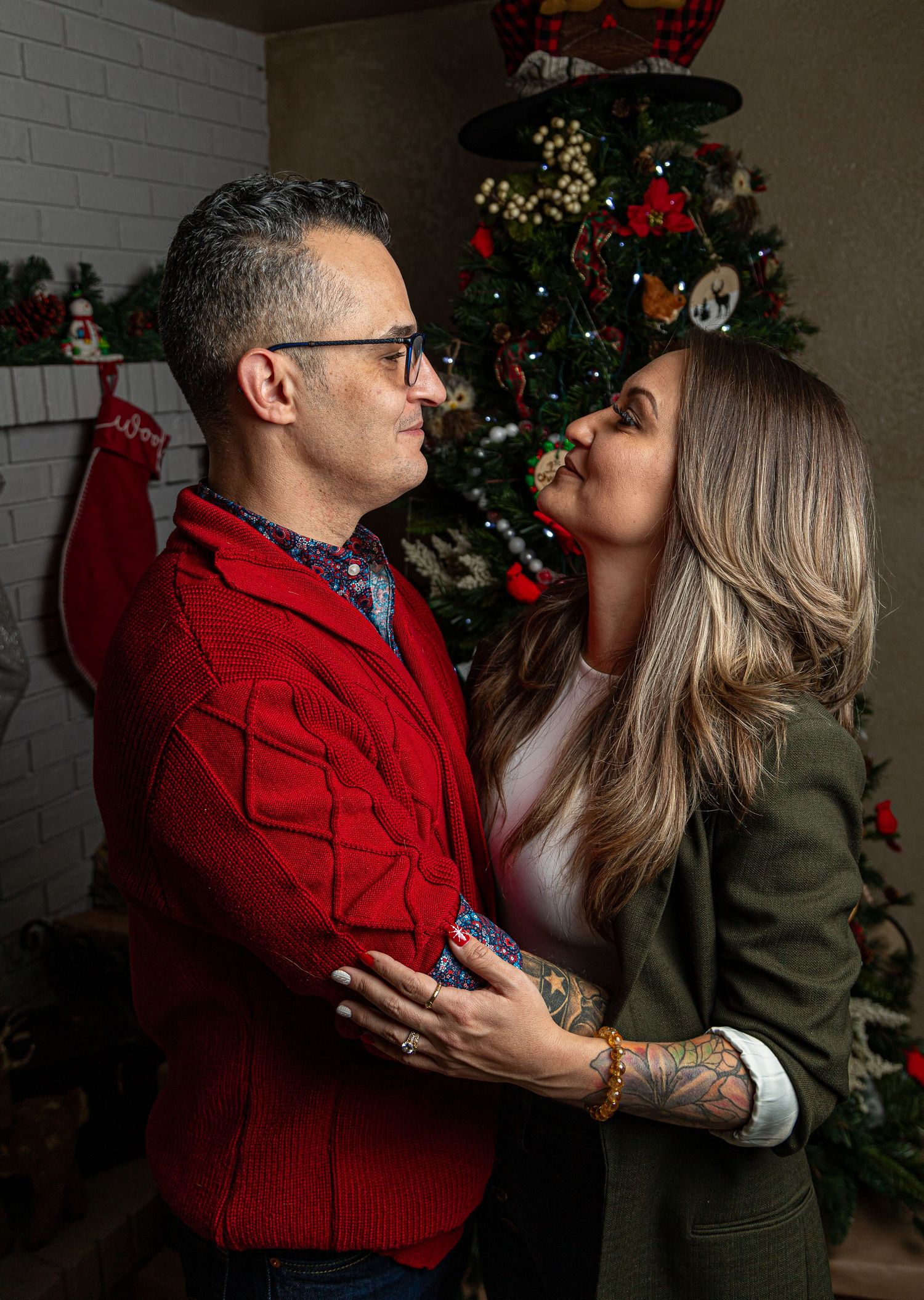 Holiday couple portrait by Colorado Springs photographer, featuring cozy Christmas decor and festive outfits.