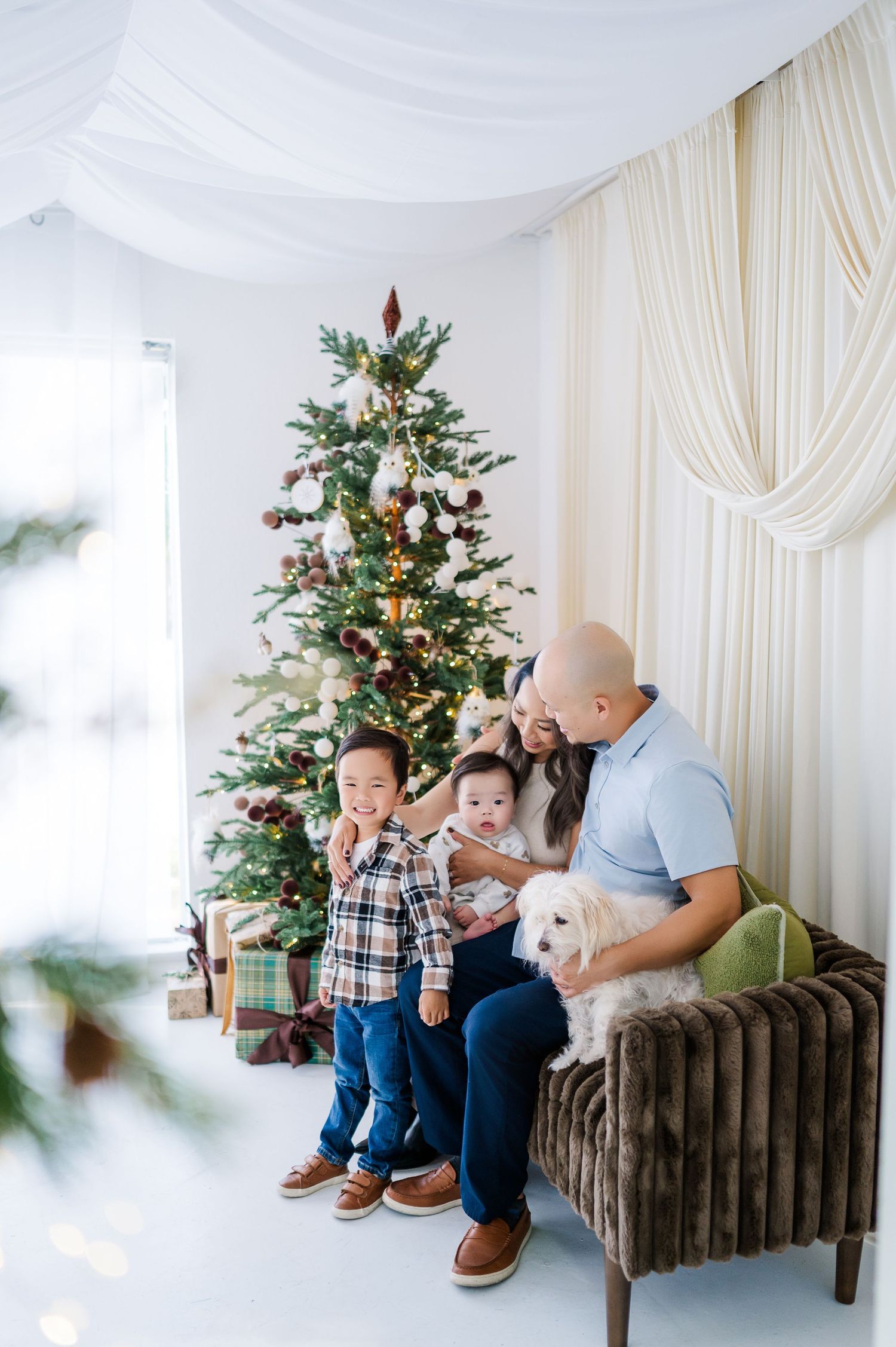 Three connected photos show a cozy holiday scene with a decorated Christmas tree and brown bench against white curtains.