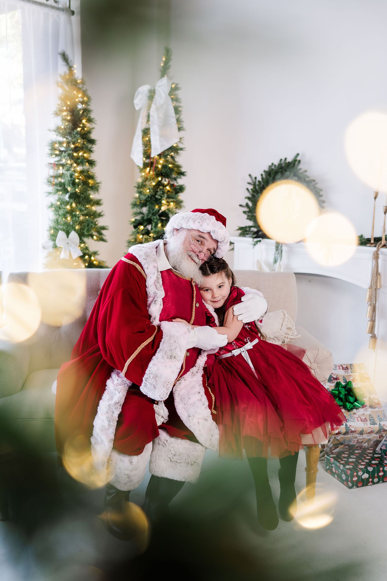 Artistic photo sequence showing Santa Claus dancing in a bright white room decorated with Christmas trees and lights.