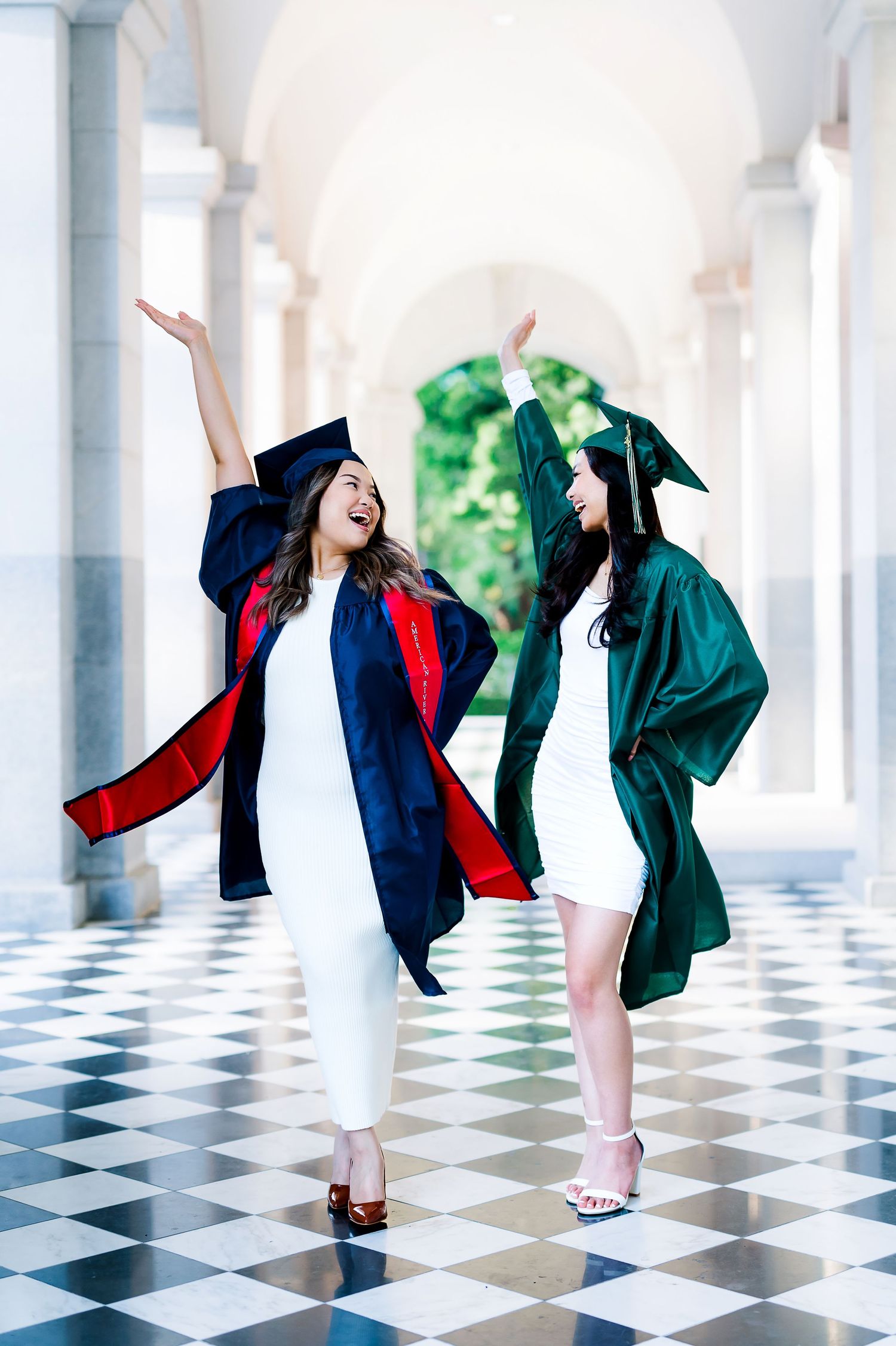 Graduation celebration photoshoot with dynamic poses on black and white tiled floor.