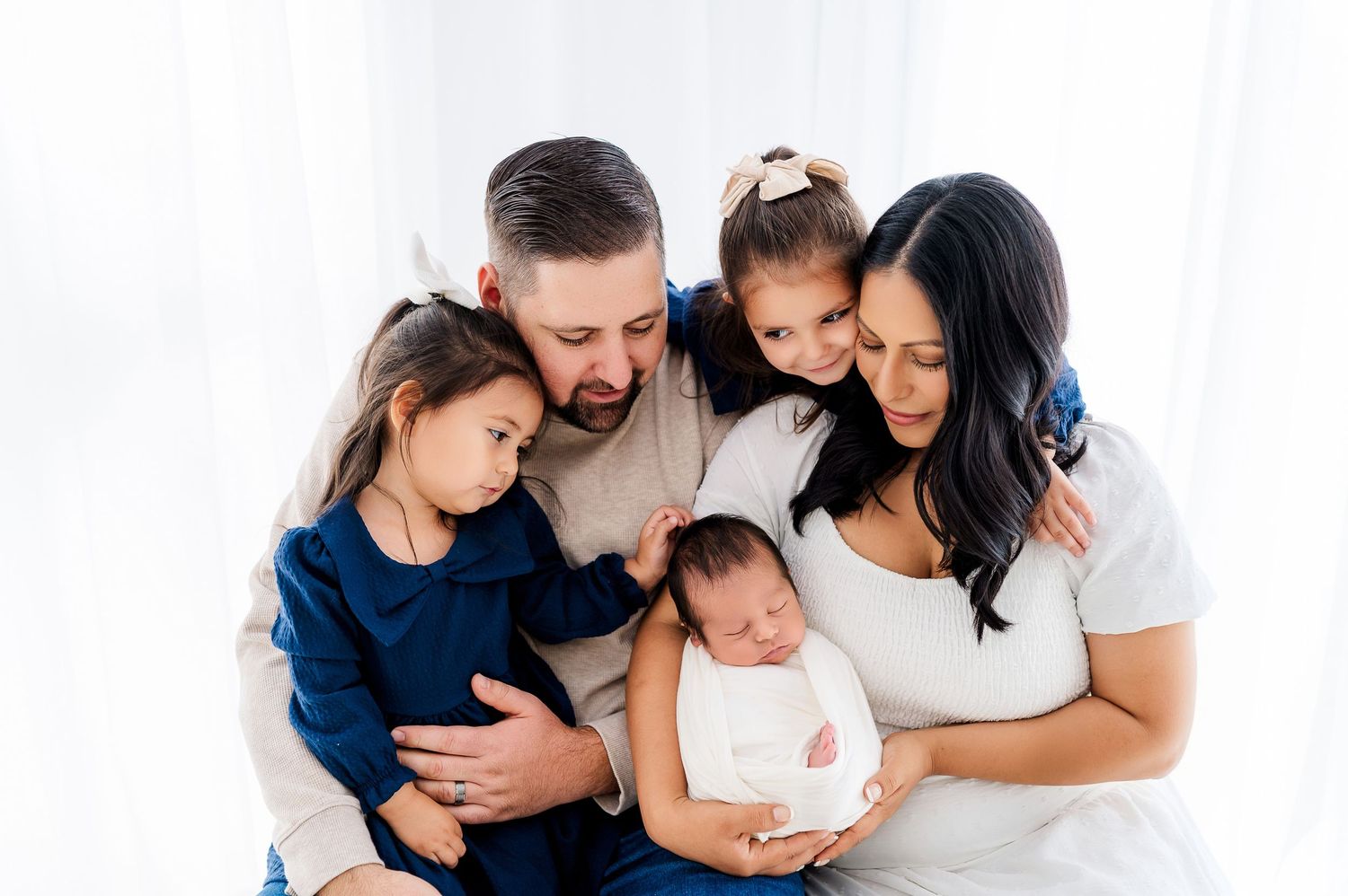 A collage of four family photos showing parents and children embracing and sharing tender moments together.