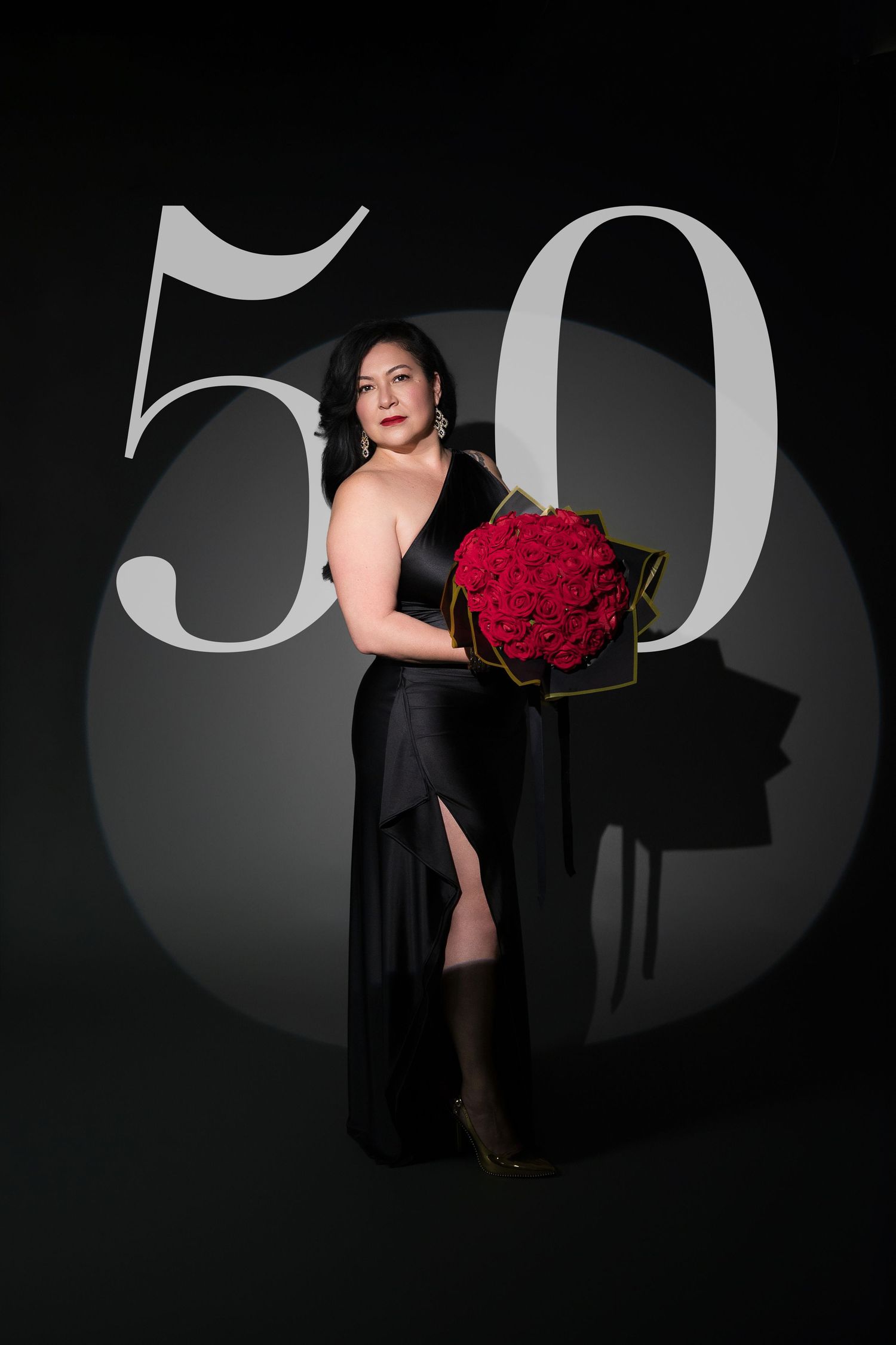 Artistic black and white photo series featuring a figure in black dress holding vibrant red roses against dark backdrop.