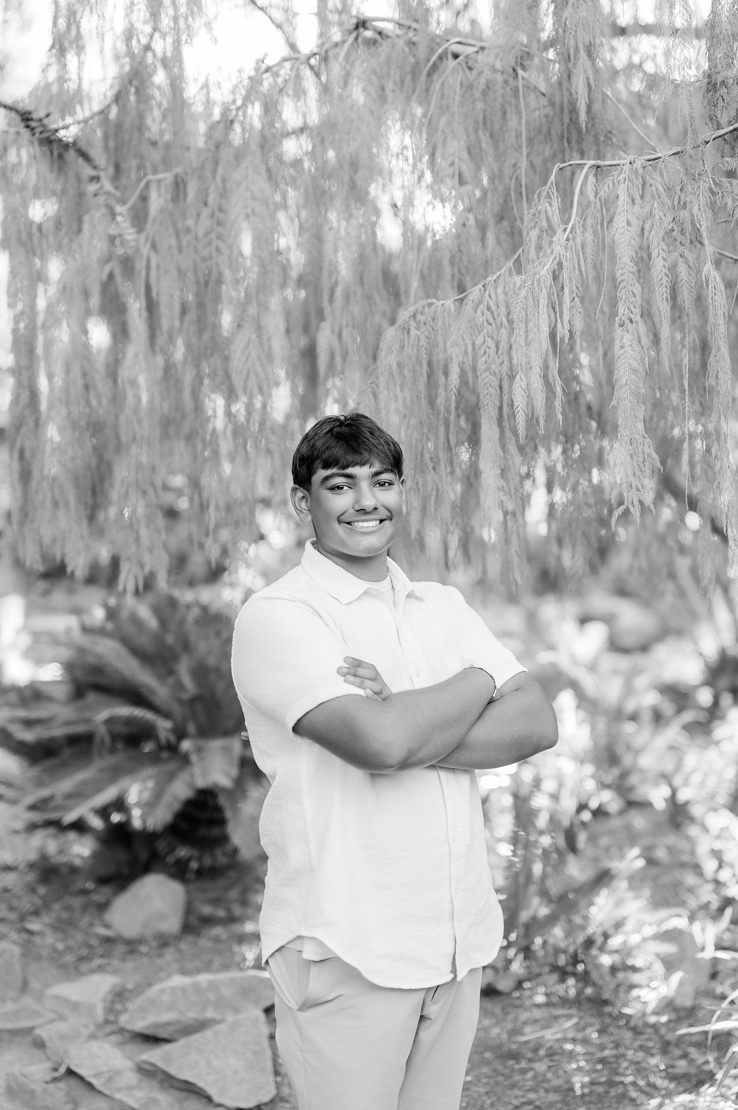Black and white photo collection capturing candid moments against a soft forest backdrop.
