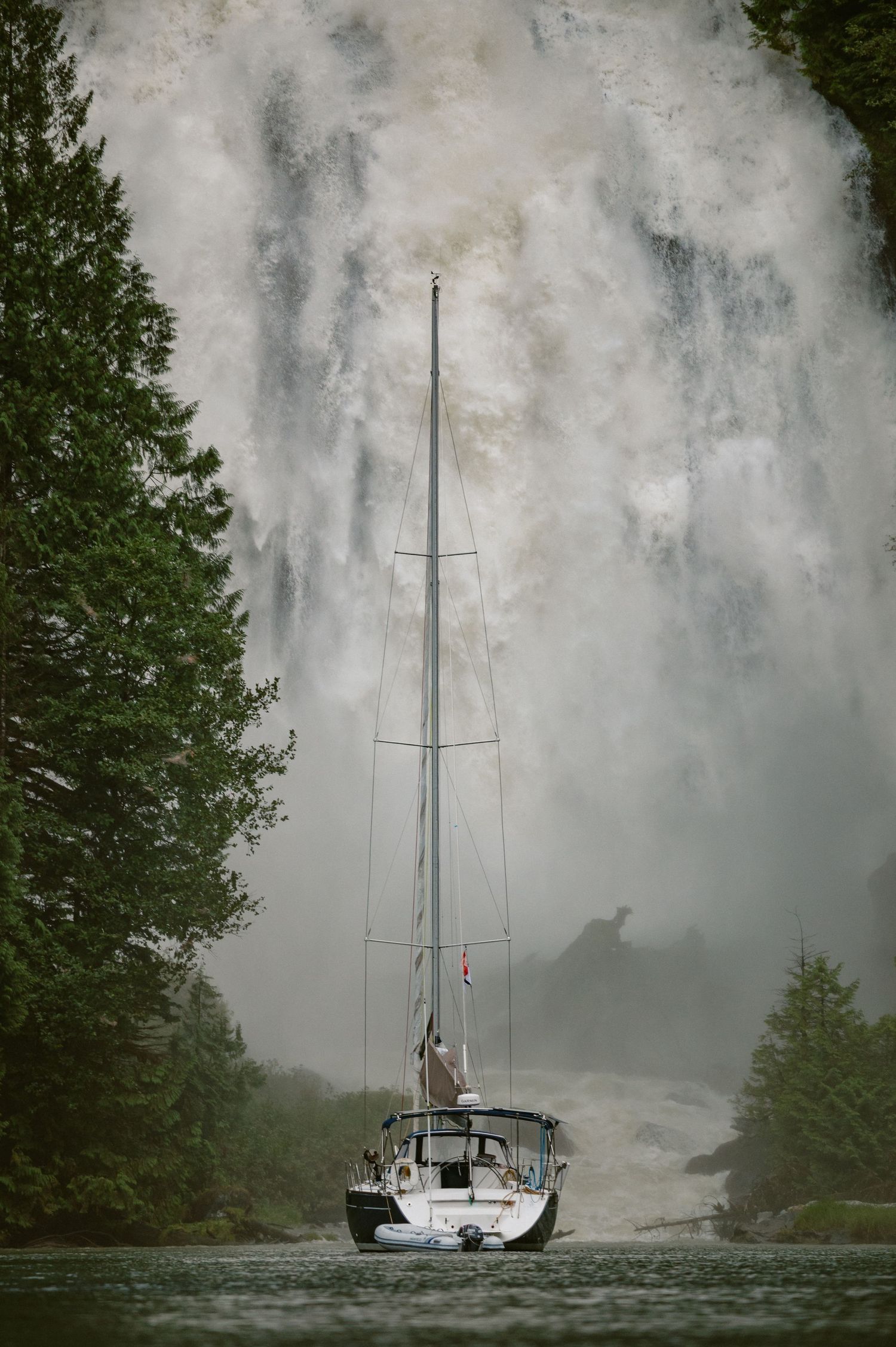 Vancouver Island Photographer.  Sailboat in front of waterfall on the west coast of BC