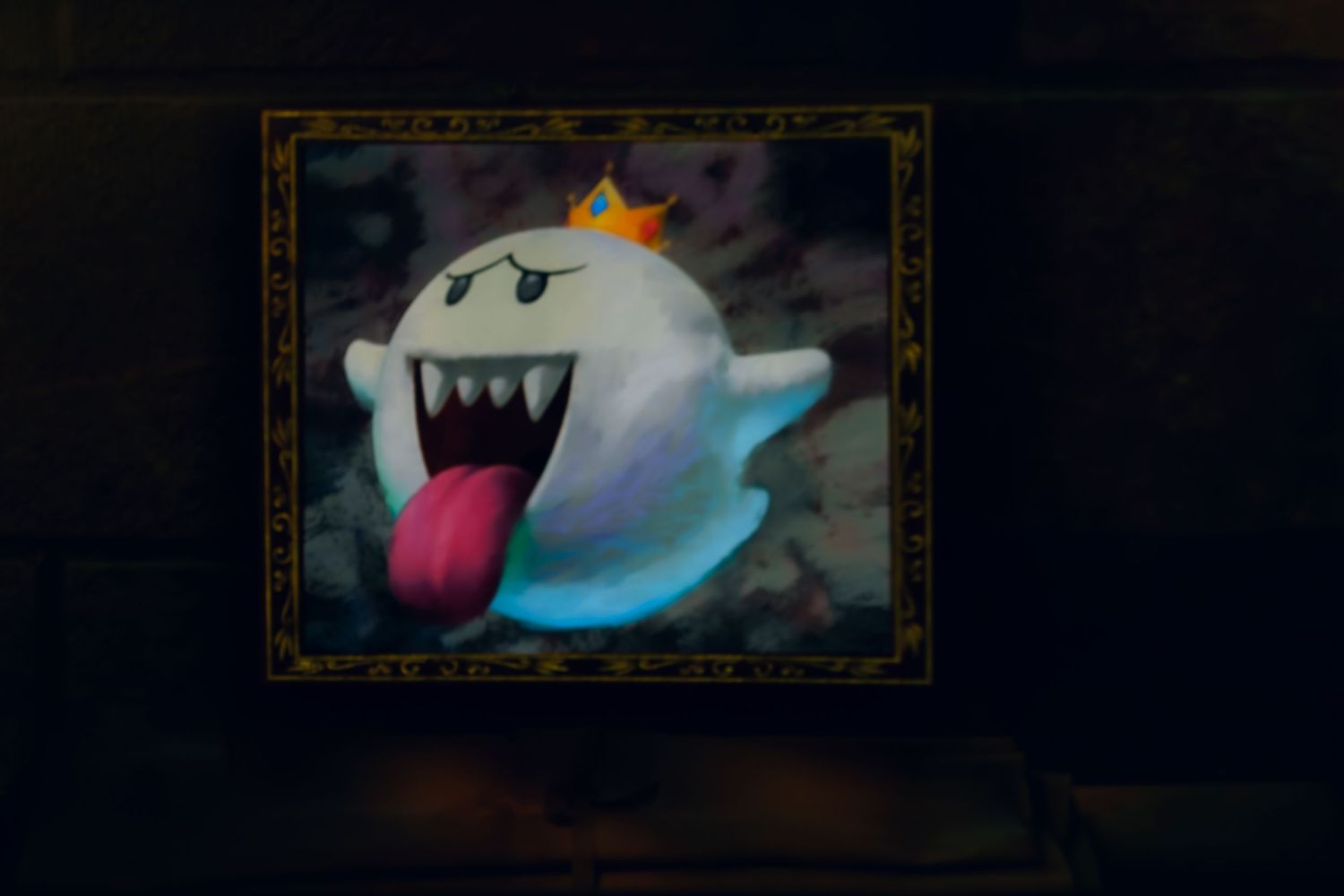 A King Boo video game character portrait shows the ghostly figure with glowing eyes, crown, and extended tongue against dark background.