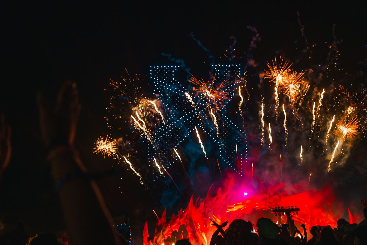 Colorful fireworks illuminate the night sky with bursts of red, blue and gold sparks creating a spectacular display.