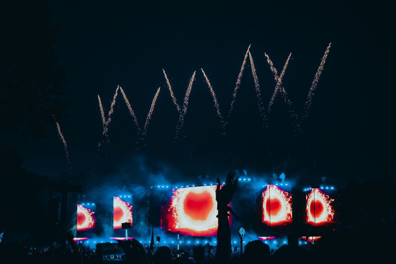 A series of abstract red and blue light trails create a mesmerizing pattern against a dark background.