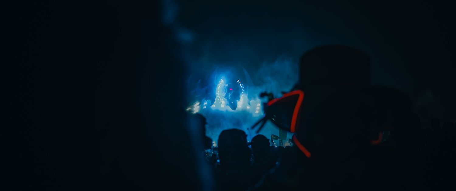 A dark blue abstract background with glowing neon lights and geometric shapes creating a futuristic atmosphere.