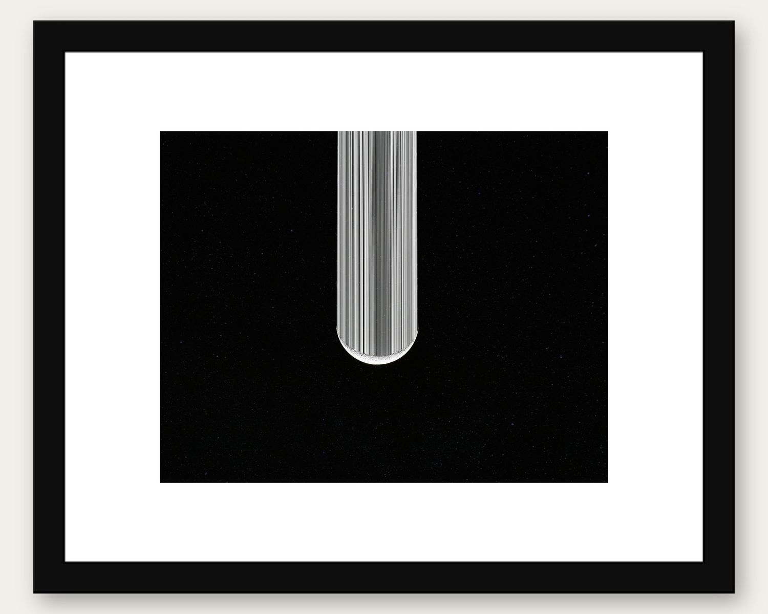 Framed black and white abstract art print featuring vertical stripes forming an arch shape on dark background.