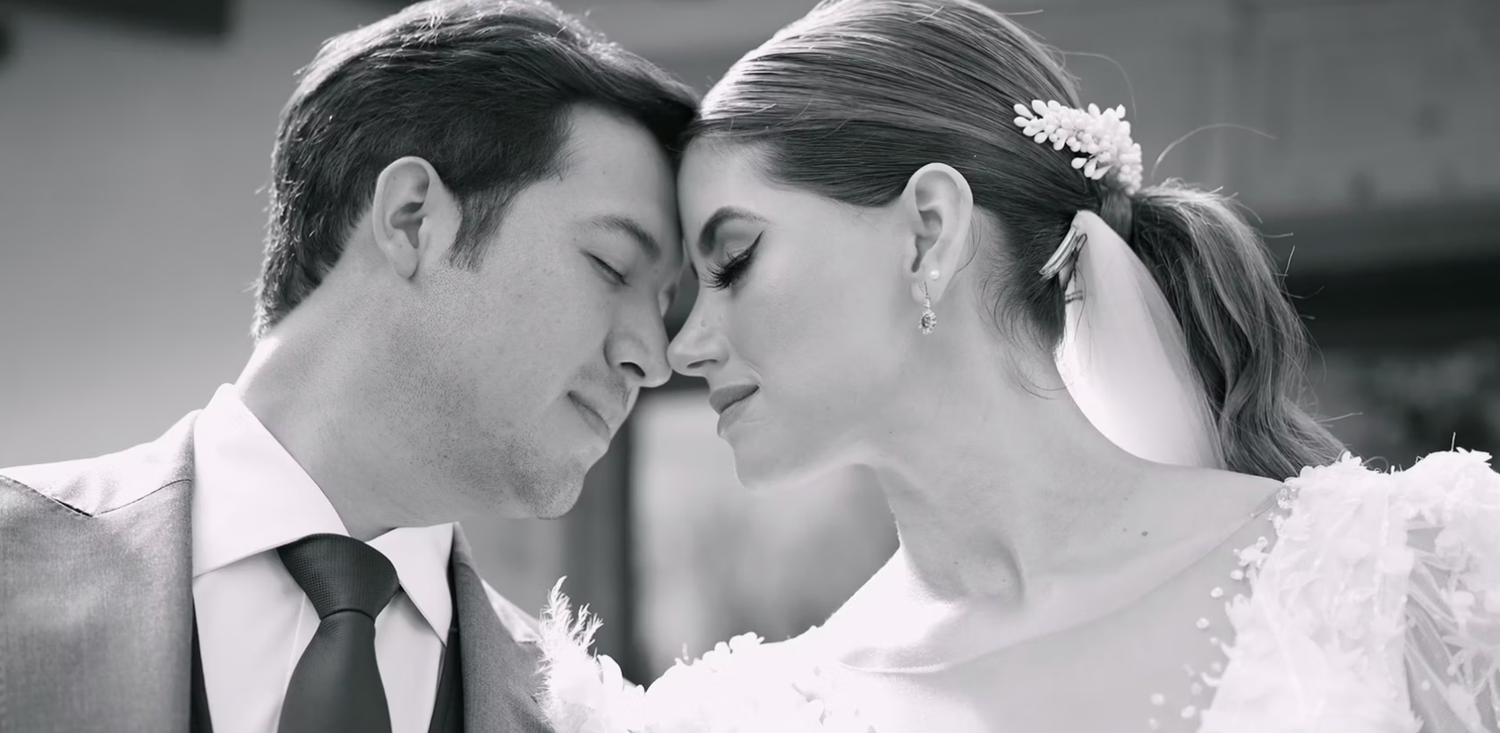 Intimate black and white portrait of newlyweds sharing a tender moment together.
