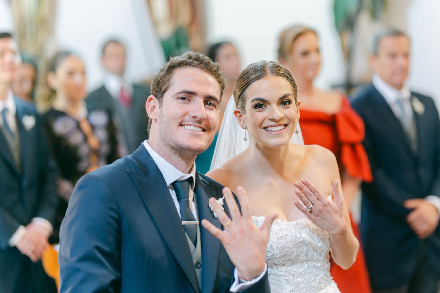 Joyful celebration inside church as newlyweds share excitement with wedding guests.