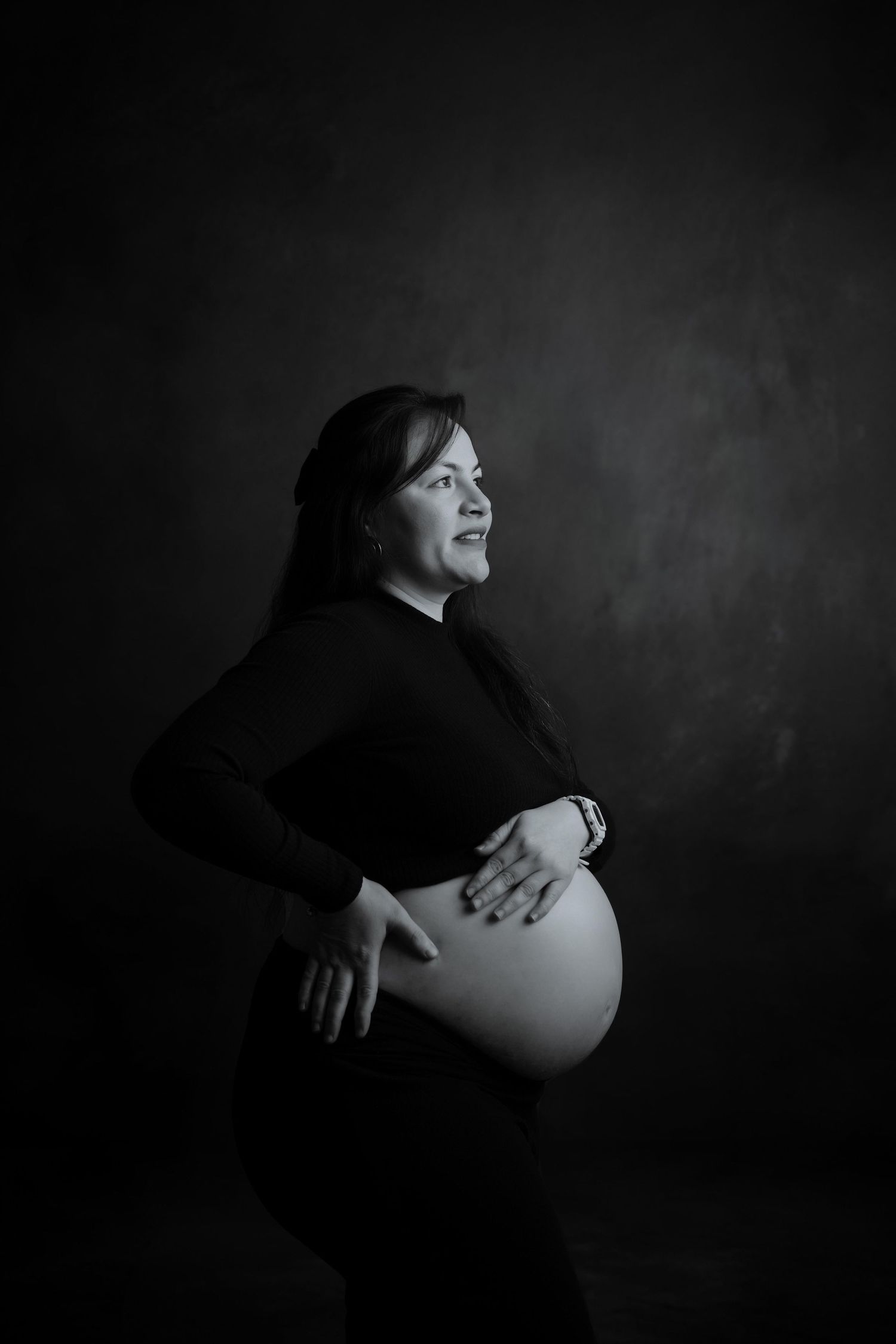 Dramatic black and white maternity portraits showing intimate moments.