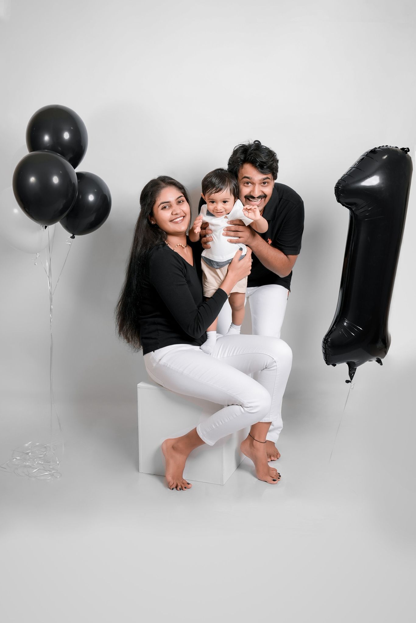 Contemporary family photos with monochromatic styling and balloon accents.