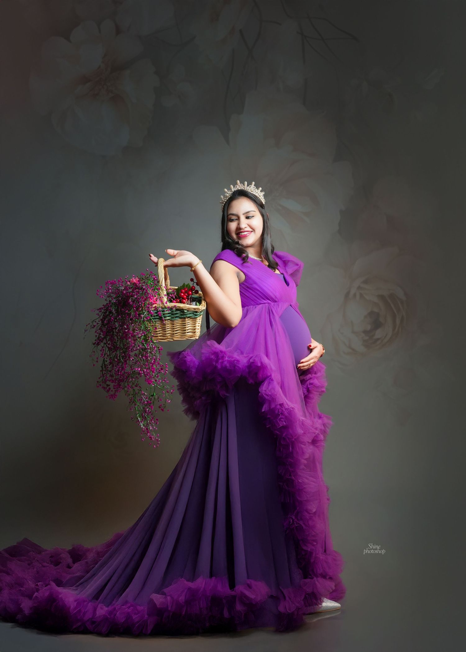 Elegant maternity photos featuring a deep purple tulle gown with dramatic ruffles.