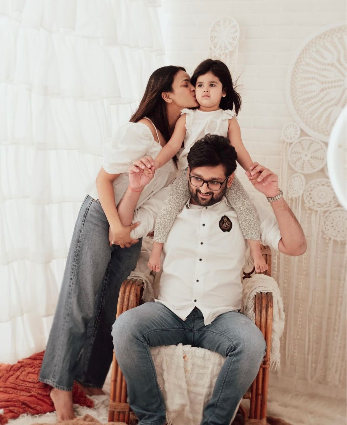 Playful family photo session with white macrame backdrop.