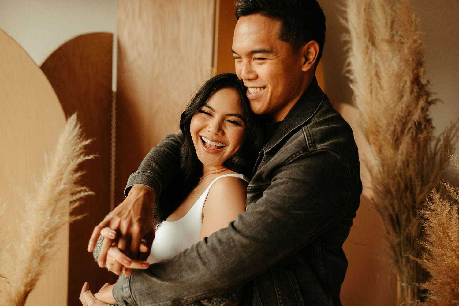 Warm-toned indoor photoshoot with soft lighting and natural expressions.