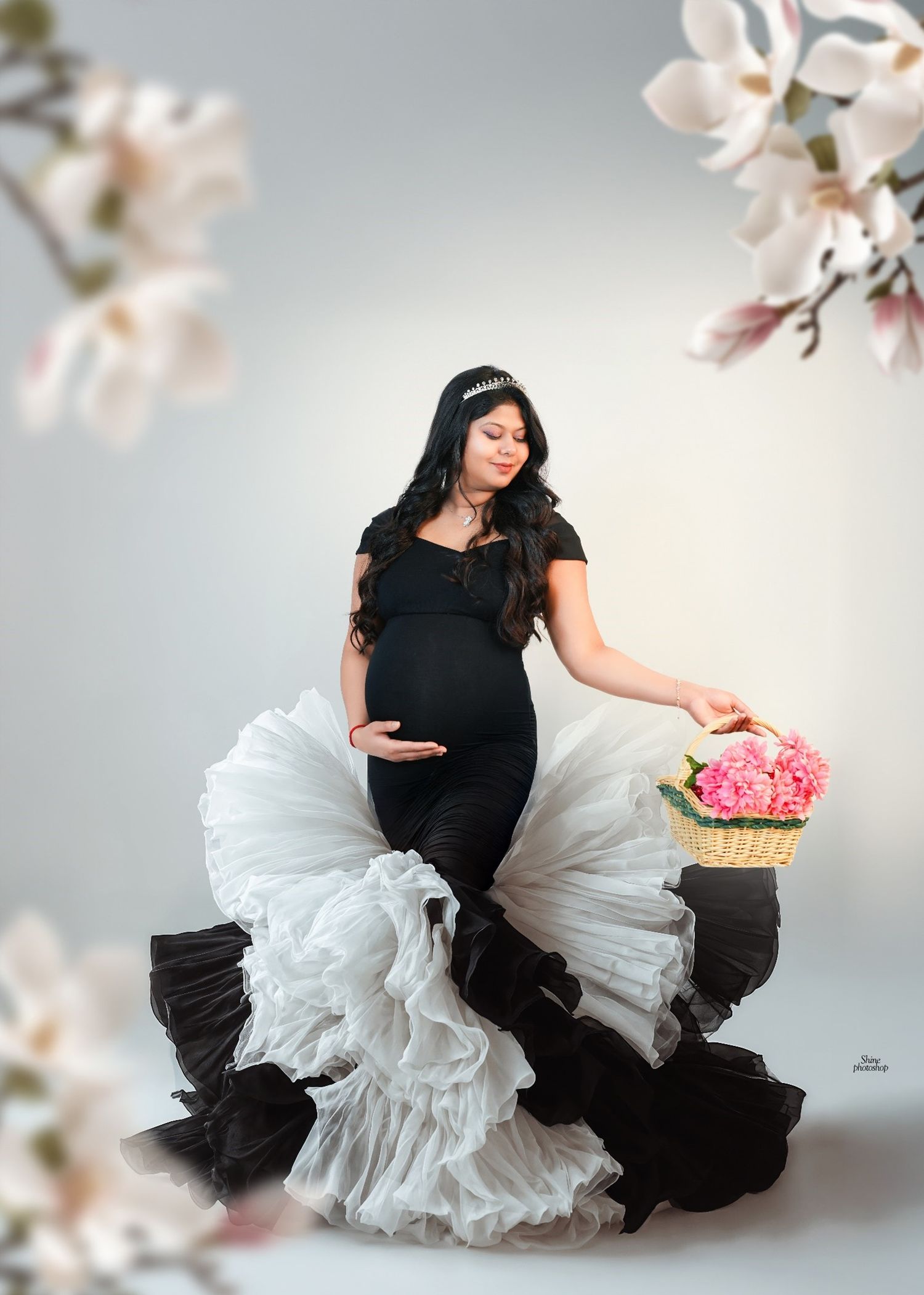 Black and white ruffled dress creates dramatic contrast in maternity photo series.