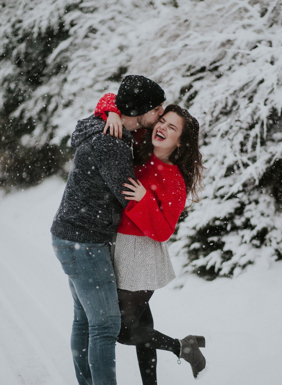 Joyful winter scene with a couple playing in the snow.