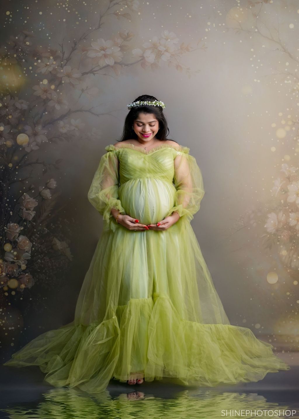 Artistic maternity portraits in a lime green tulle gown with magical bokeh lighting effects.