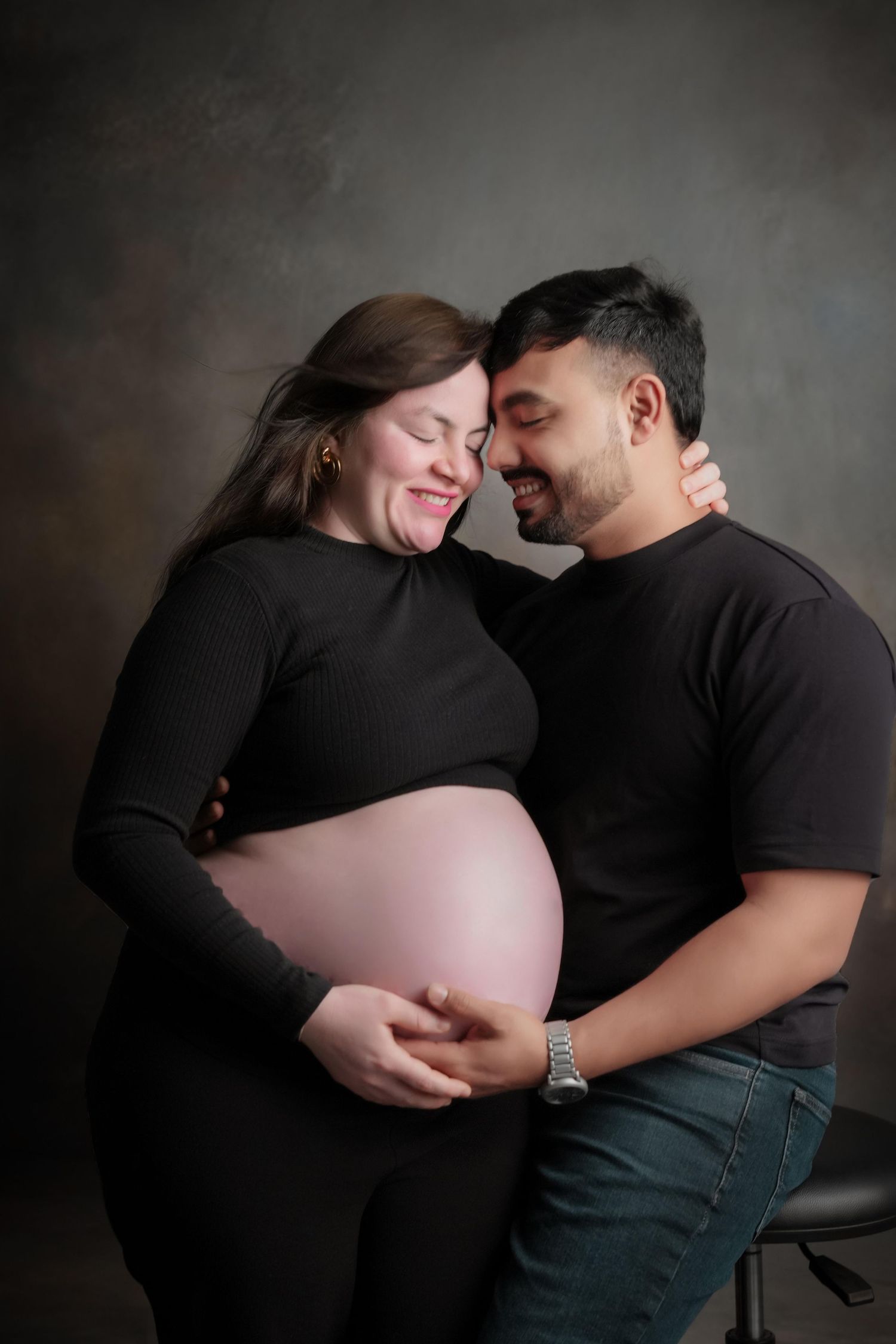 Intimate black and white maternity photos capture expecting couple's connection.