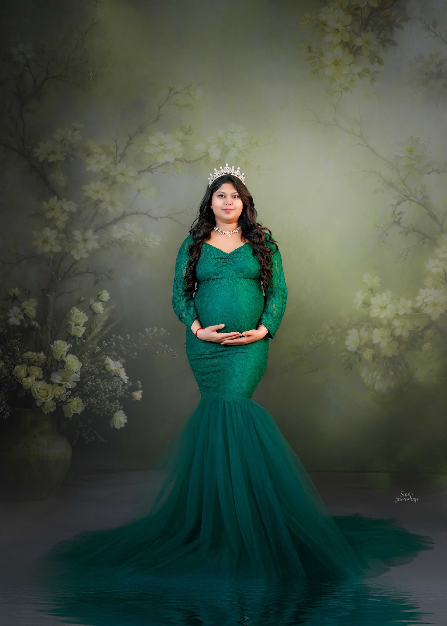 Enchanting maternity portraits in an emerald green gown with nature-inspired backdrop.