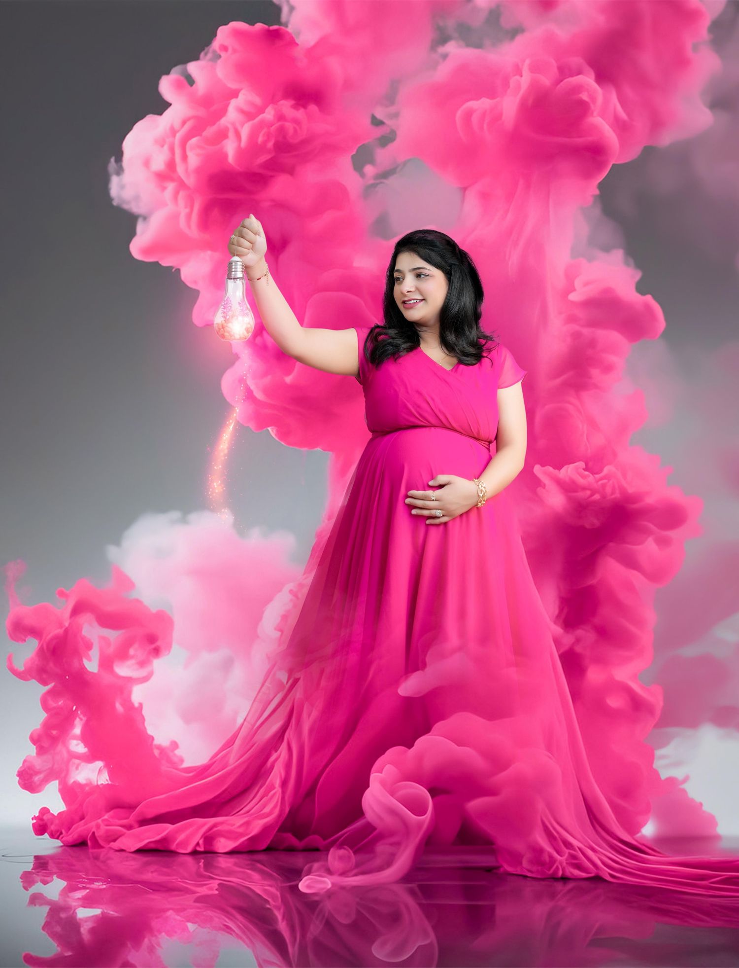 Dramatic maternity photos with flowing pink smoke effects and grey backdrop.