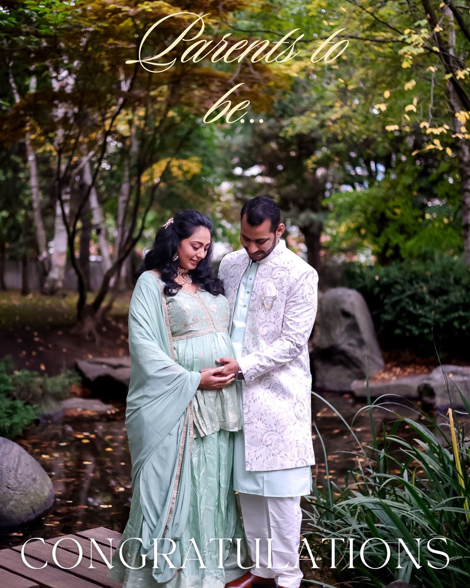 Couple in traditional mint green and white Indian attire pose intimately in a garden setting.