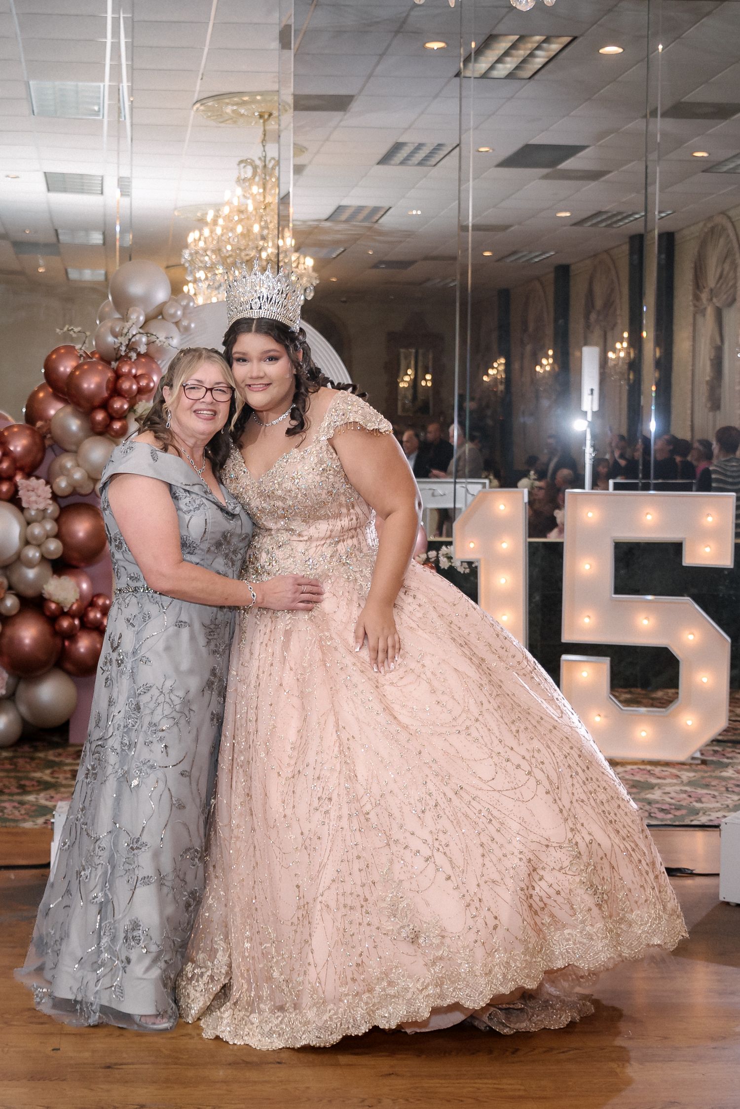 Formal event with large light-up numbers and elegant balloon arrangements.