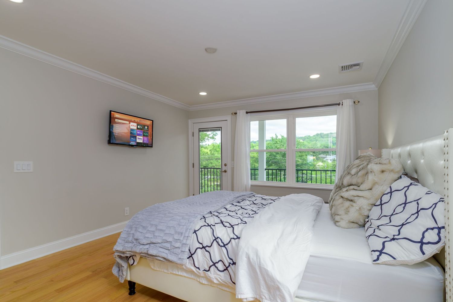 Bright bedroom with navy and white decor and natural light.