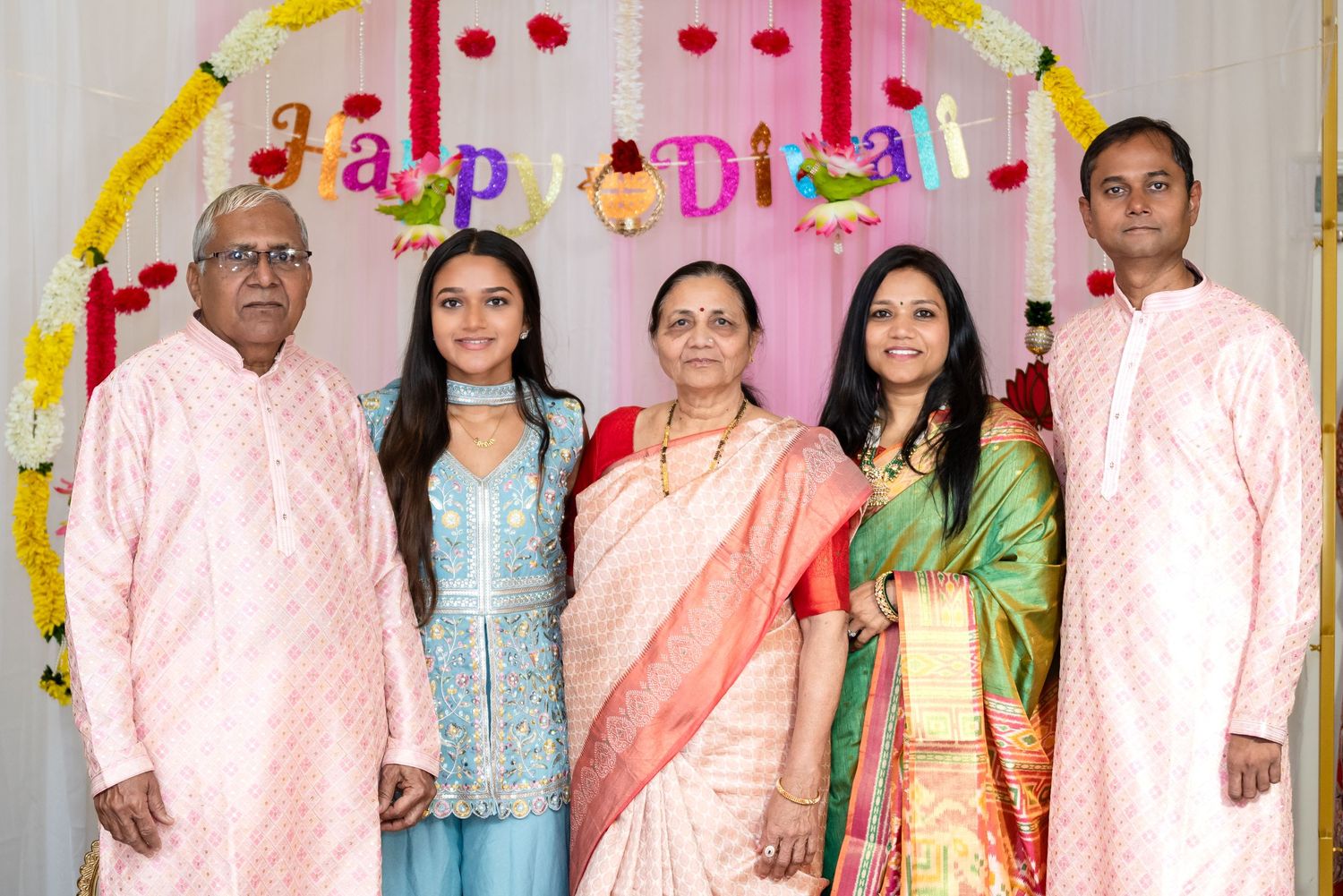 Festive celebration with colorful decorations and guests in traditional South Asian attire.
