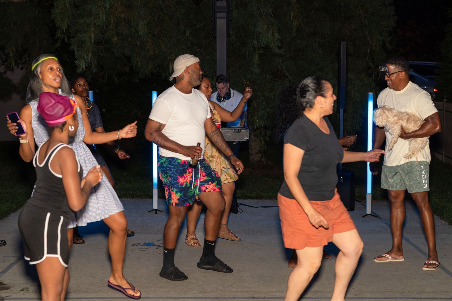 People dancing and having fun at an outdoor nighttime event.
