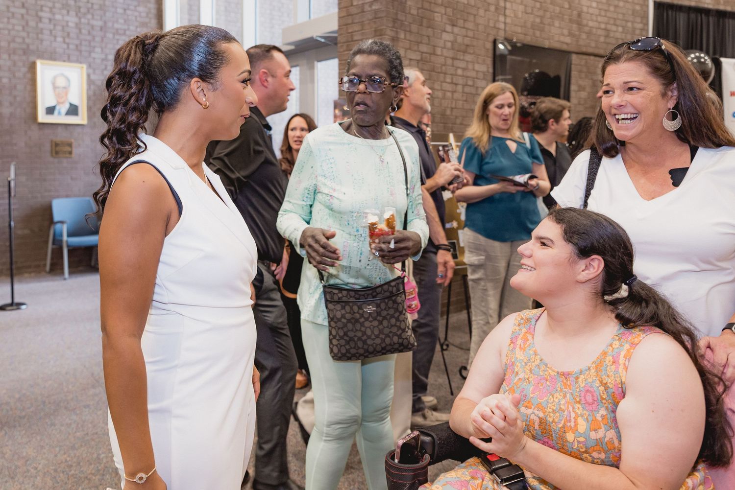 Casual interactions between event attendees at branded community gathering.