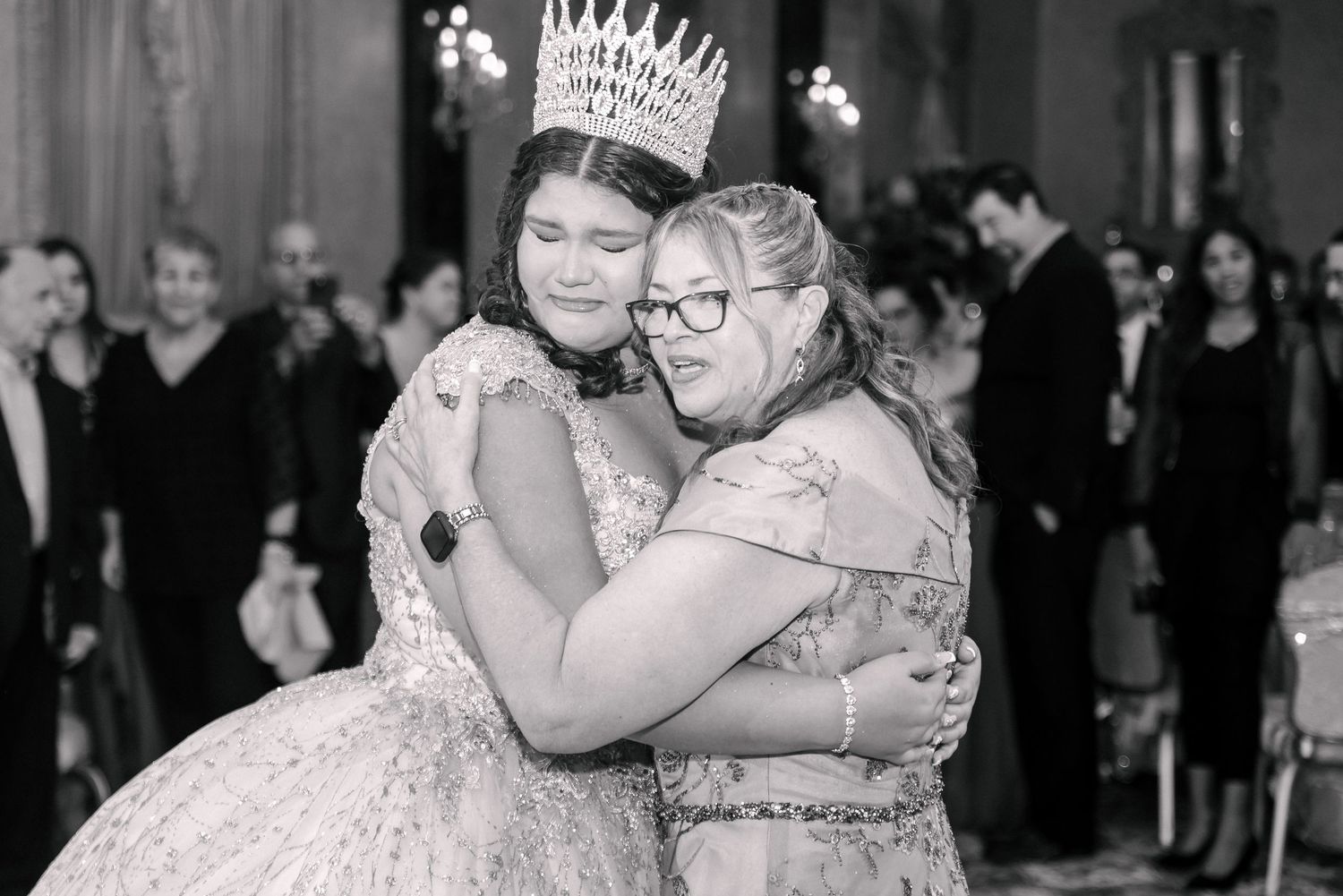 Black and white photo of an emotional celebration moment during a formal event.