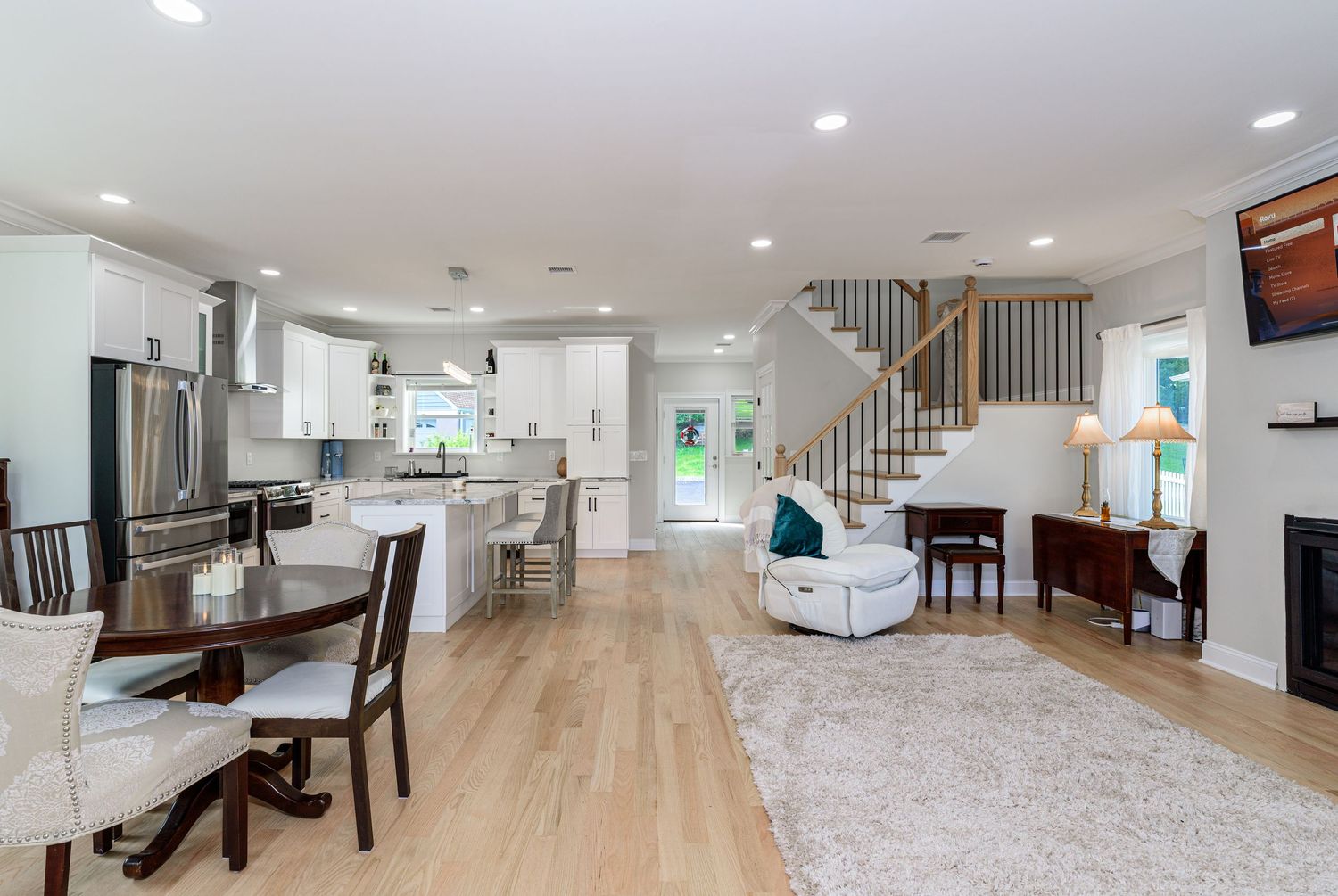 Spacious finished basement with white walls and modern furnishings.