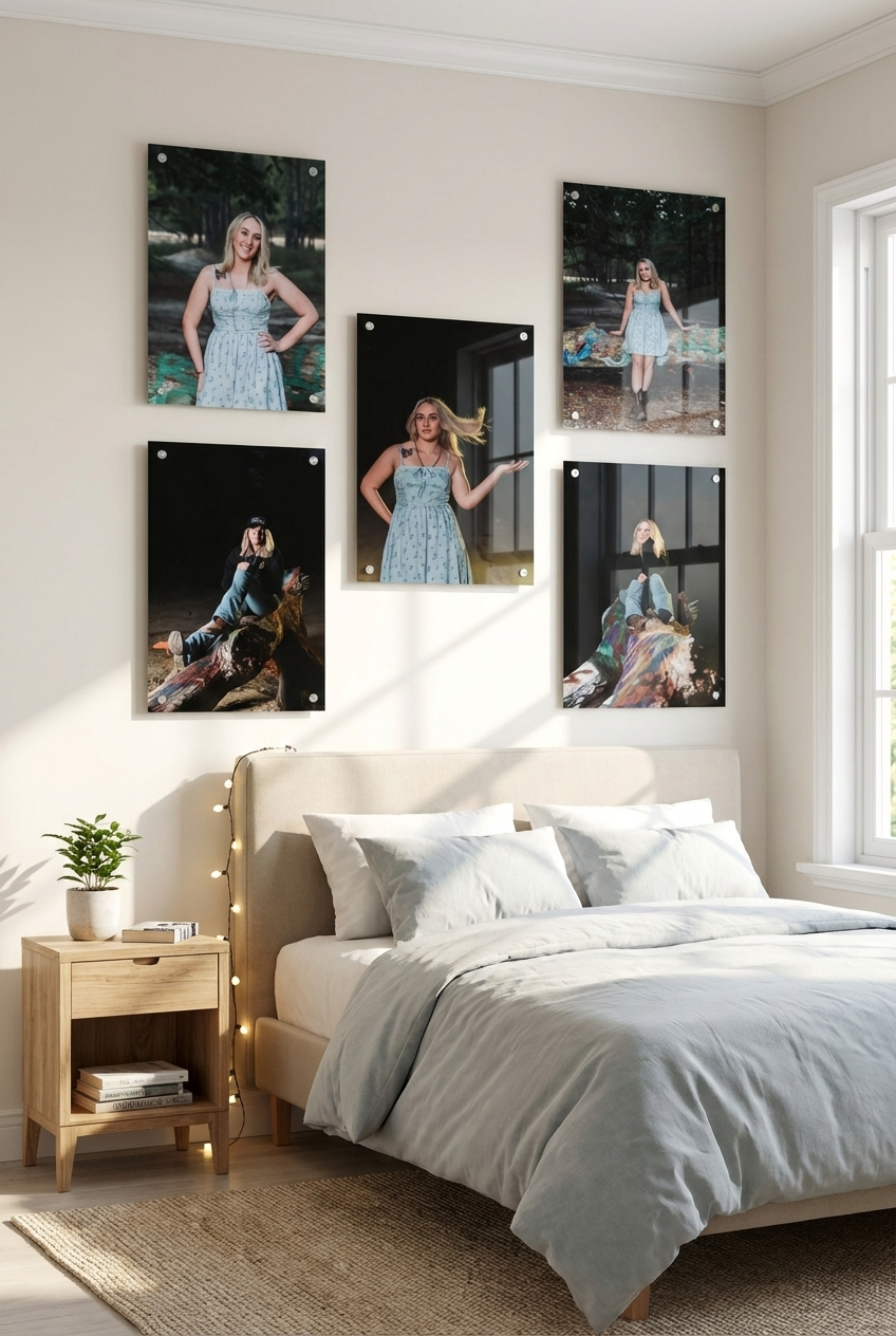 A series of black and white photographs displayed on a white wall above a cozy bed with light gray bedding.