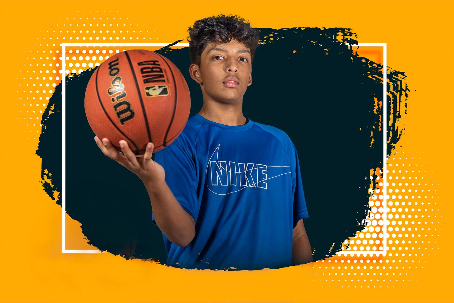 Basketball player in blue jersey holds ball against vibrant orange background in dynamic sports portrait.