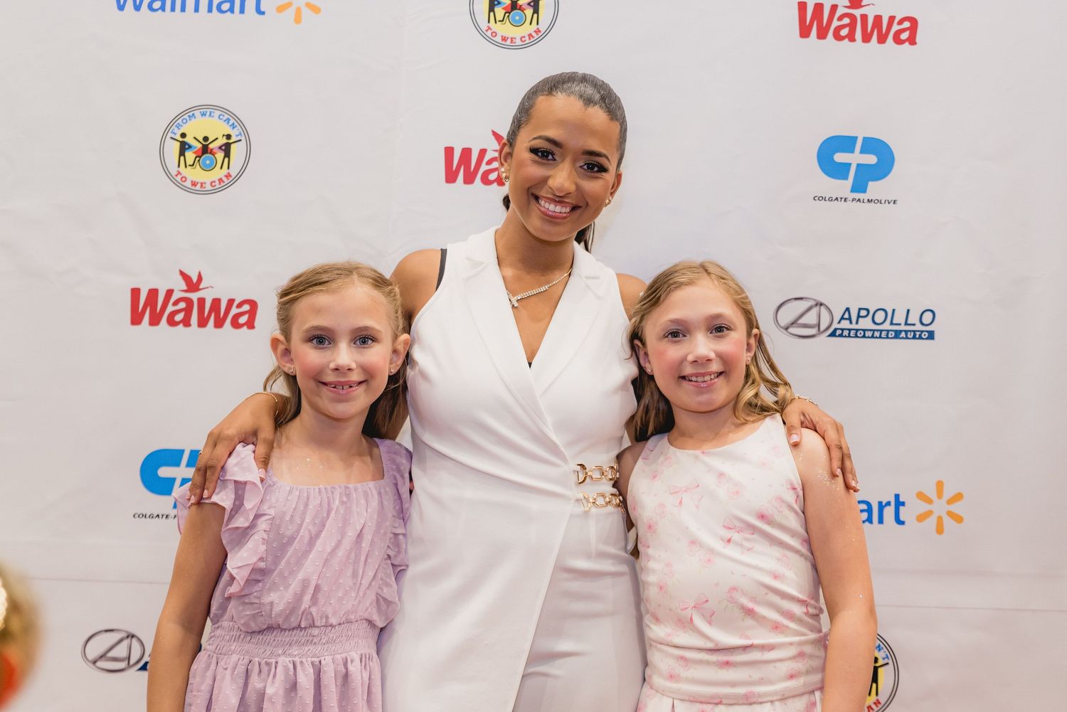 Group photo session at formal event with Walmart and Wawa logos visible in background.