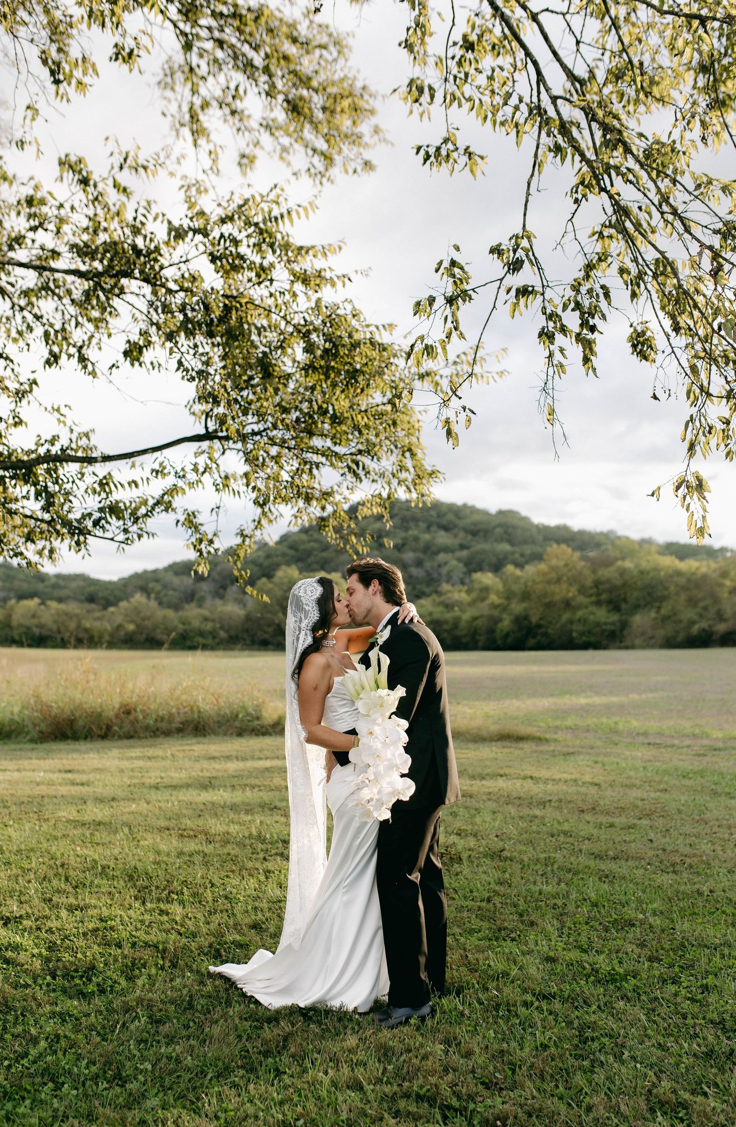 A bride and groom posing for their luxury photographer during their wedding day in Nashville, TN