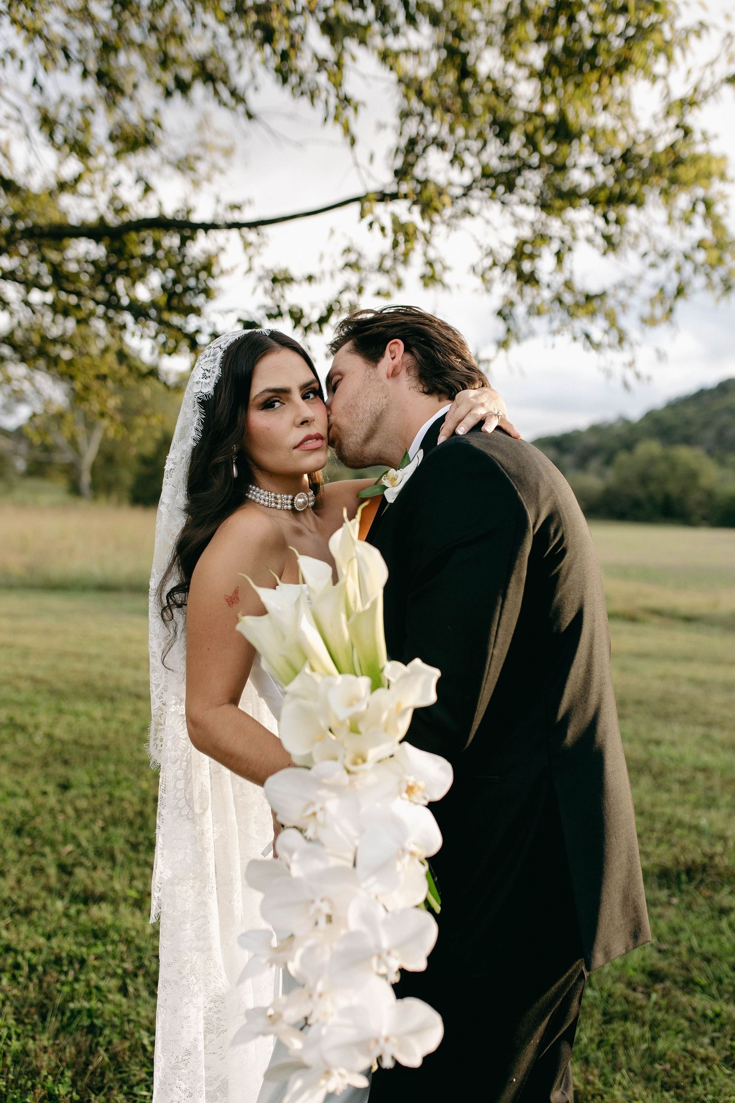 A bride and groom posing for their luxury photographer during their wedding day in Nashville, TN