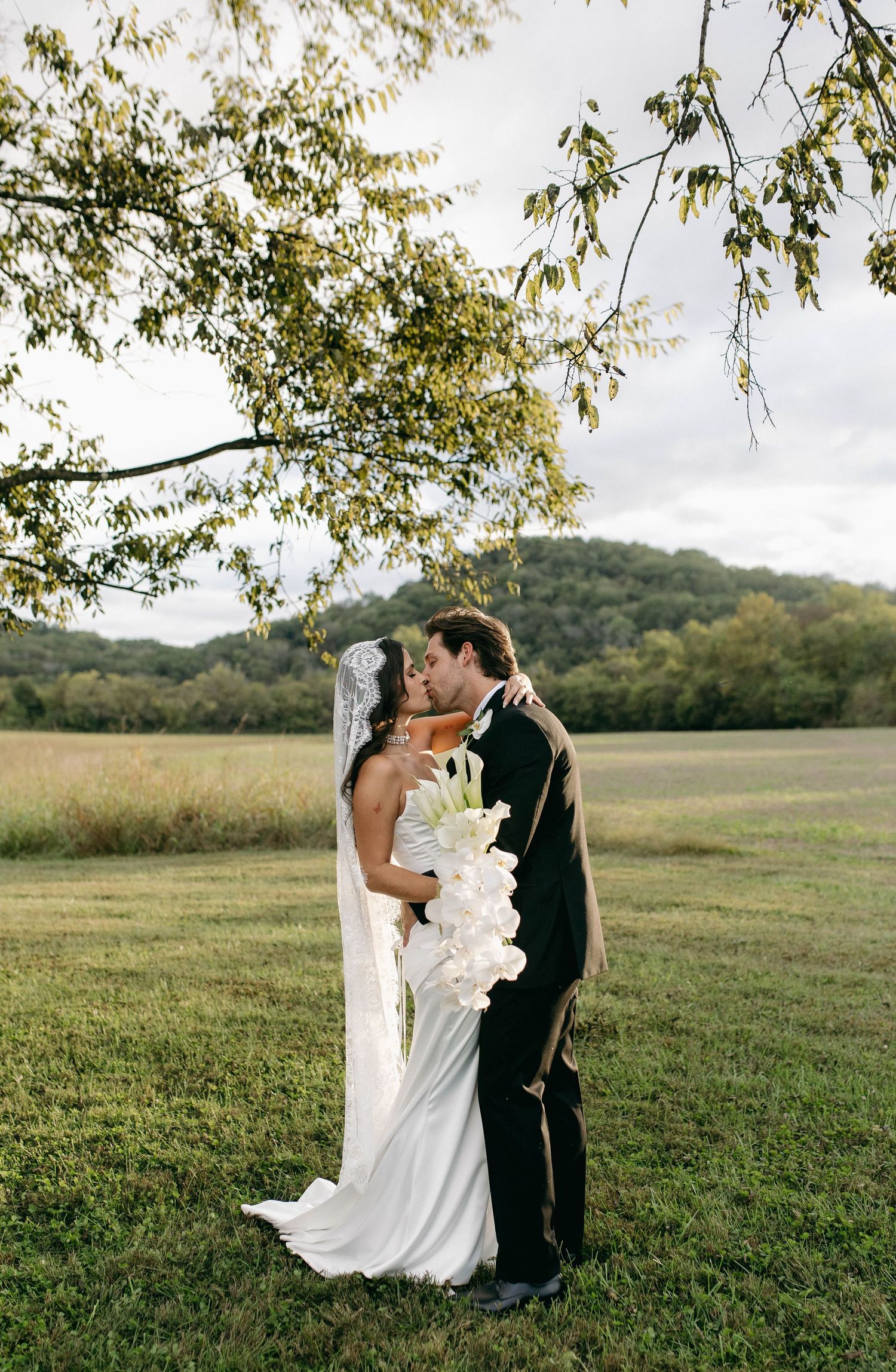 A bride and groom posing for their luxury photographer during their wedding day in Nashville, TN