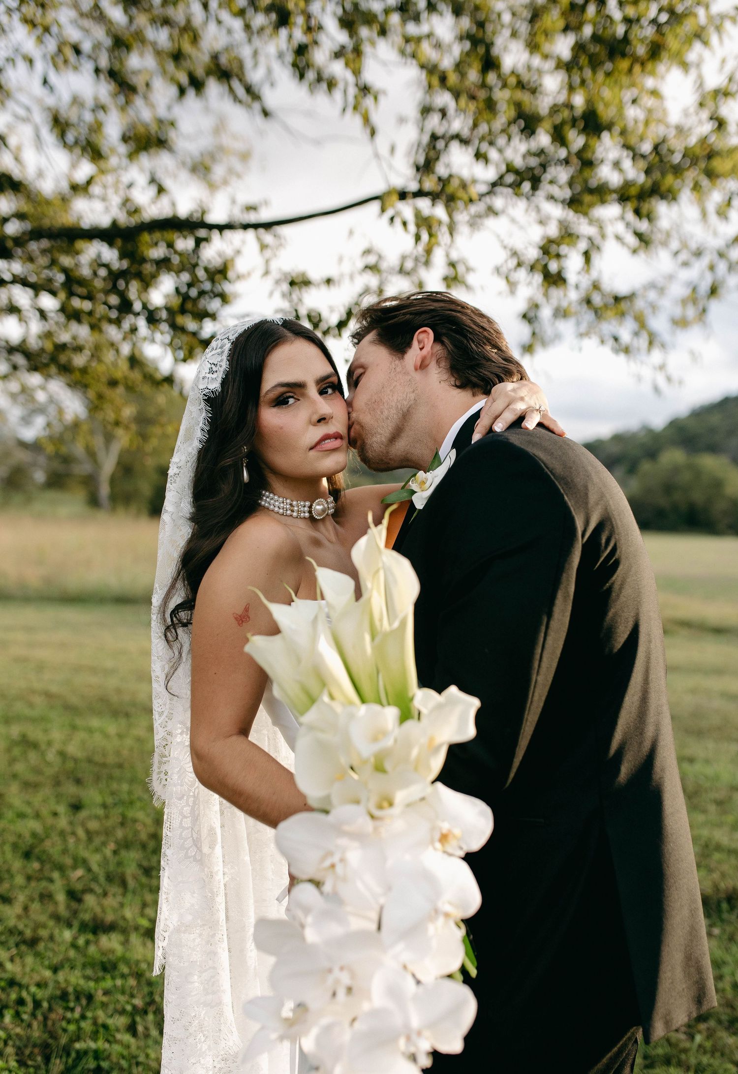 A bride and groom posing for their luxury photographer during their wedding day in Nashville, TN