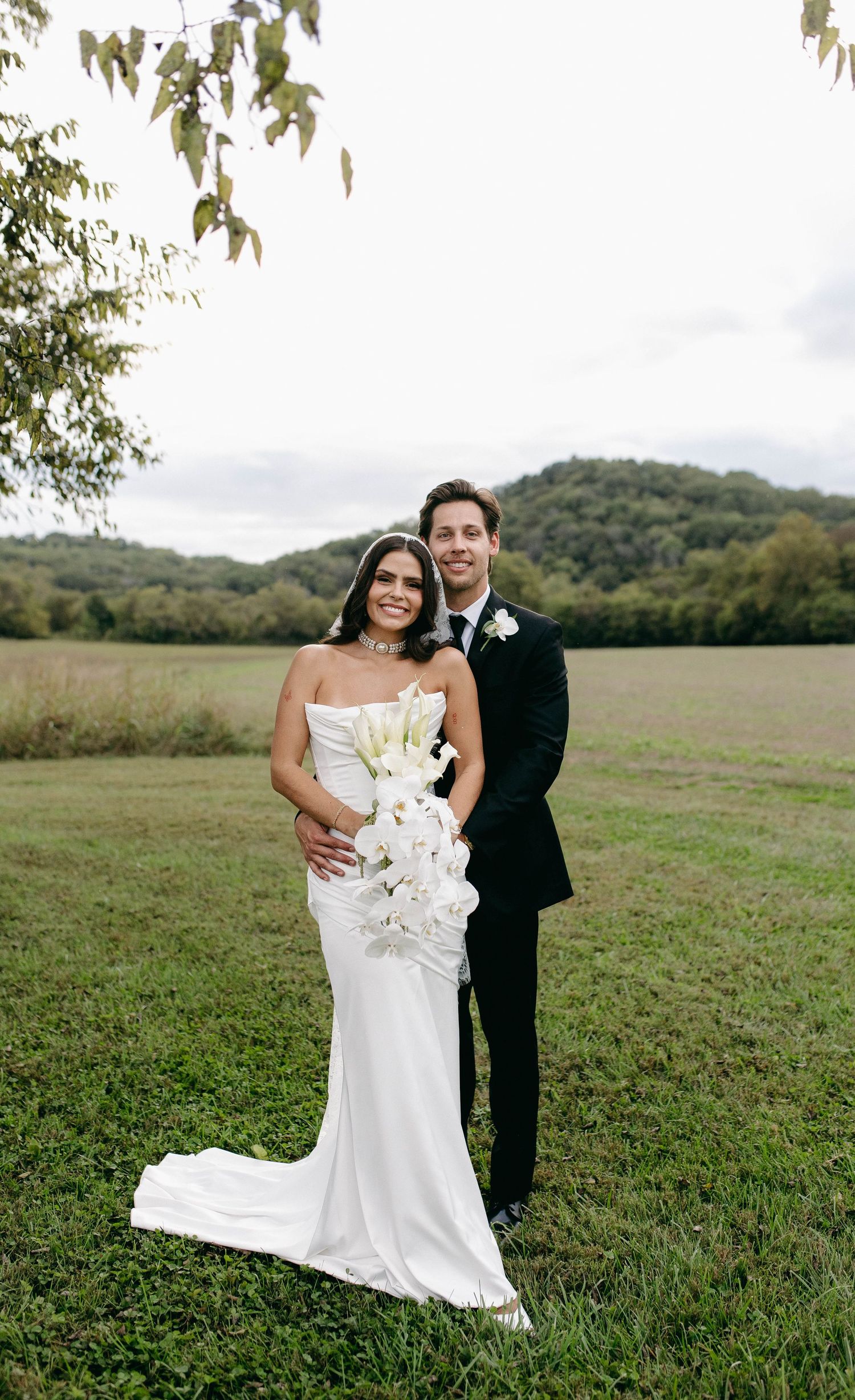A bride and groom posing for their luxury photographer during their wedding day in Nashville, TN