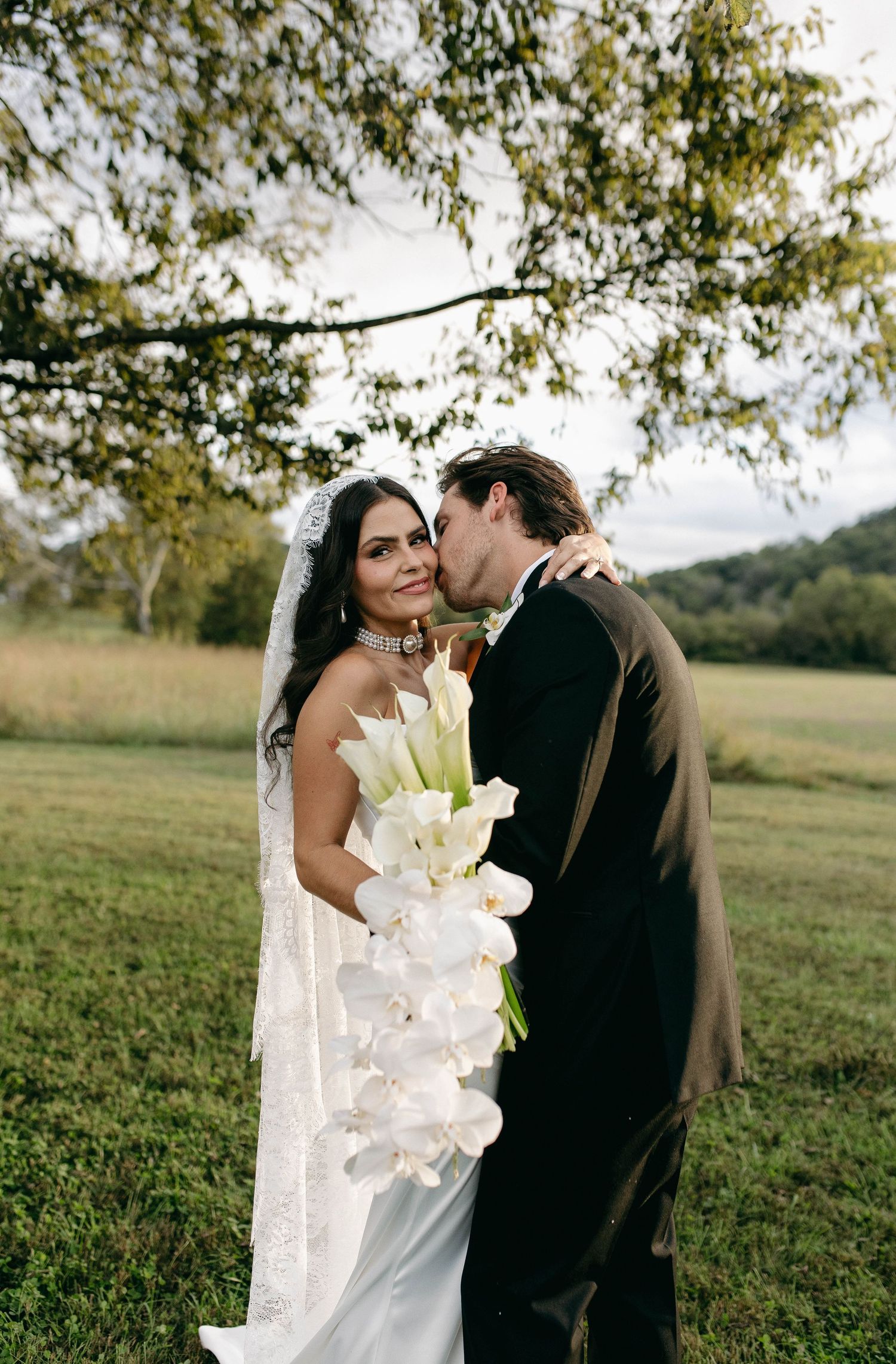 A bride and groom posing for their luxury photographer during their wedding day in Nashville, TN
