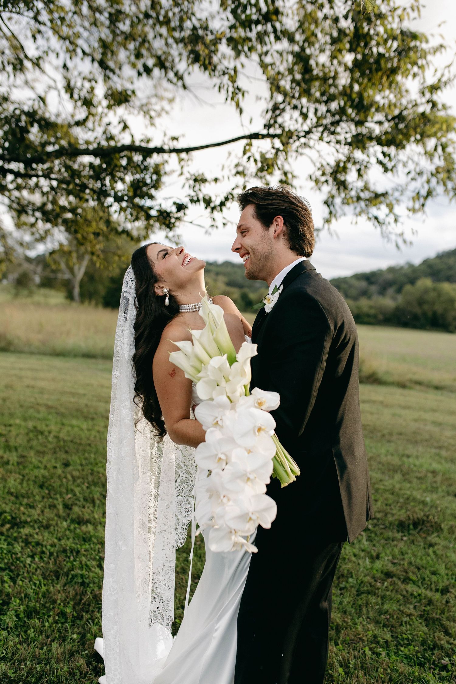 A bride and groom posing for their luxury photographer during their wedding day in Nashville, TN