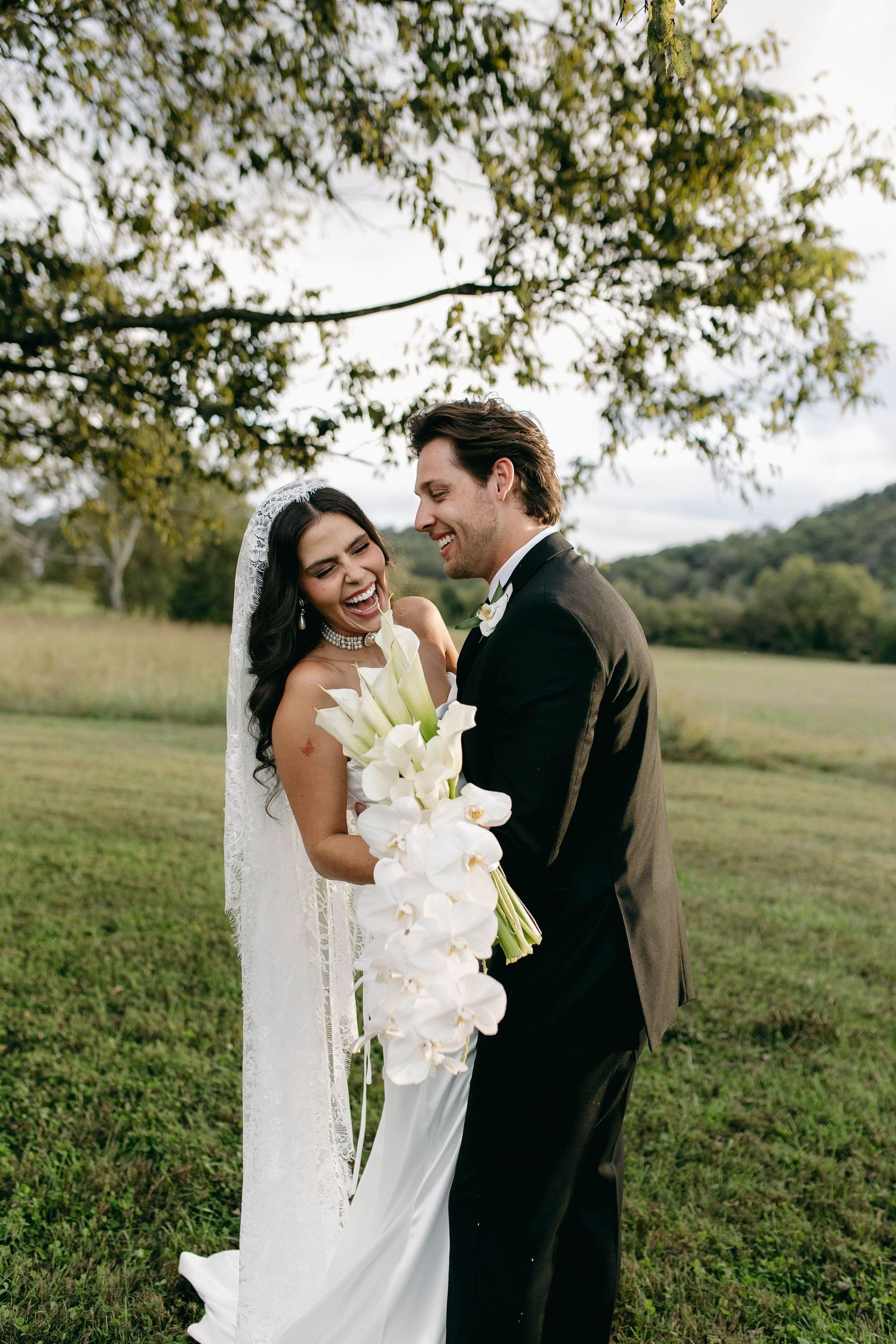 A bride and groom posing for their luxury photographer during their wedding day in Nashville, TN