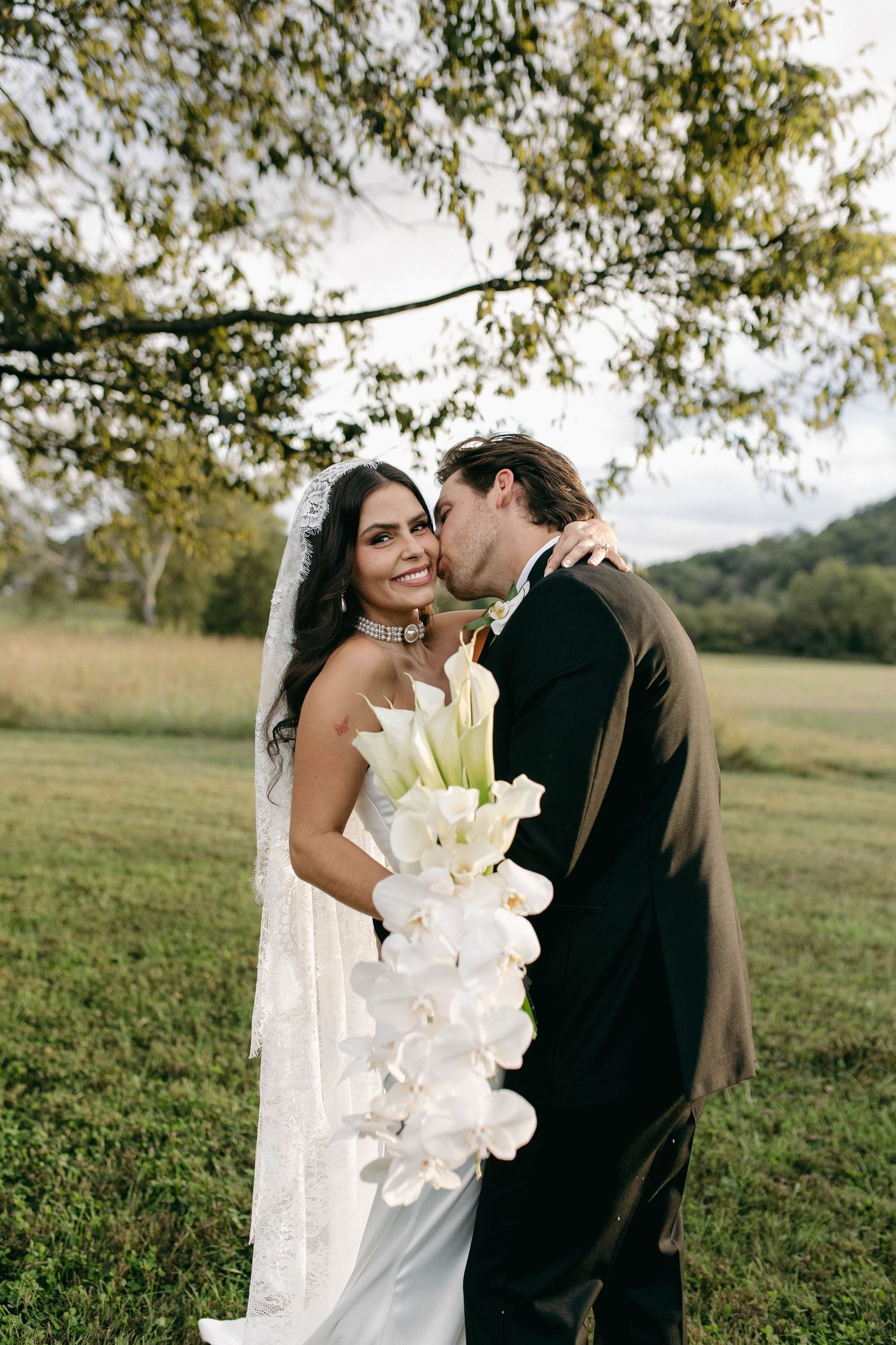 A bride and groom posing for their luxury photographer during their wedding day in Nashville, TN