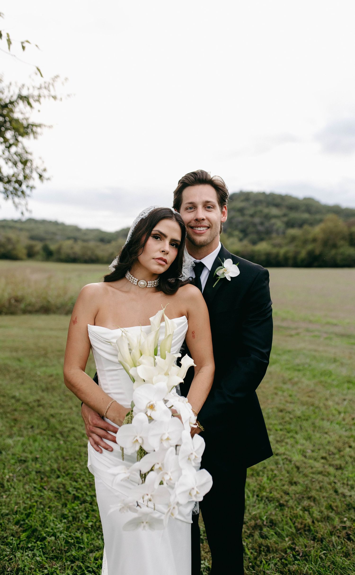 A bride and groom posing for their luxury photographer during their wedding day in Nashville, TN