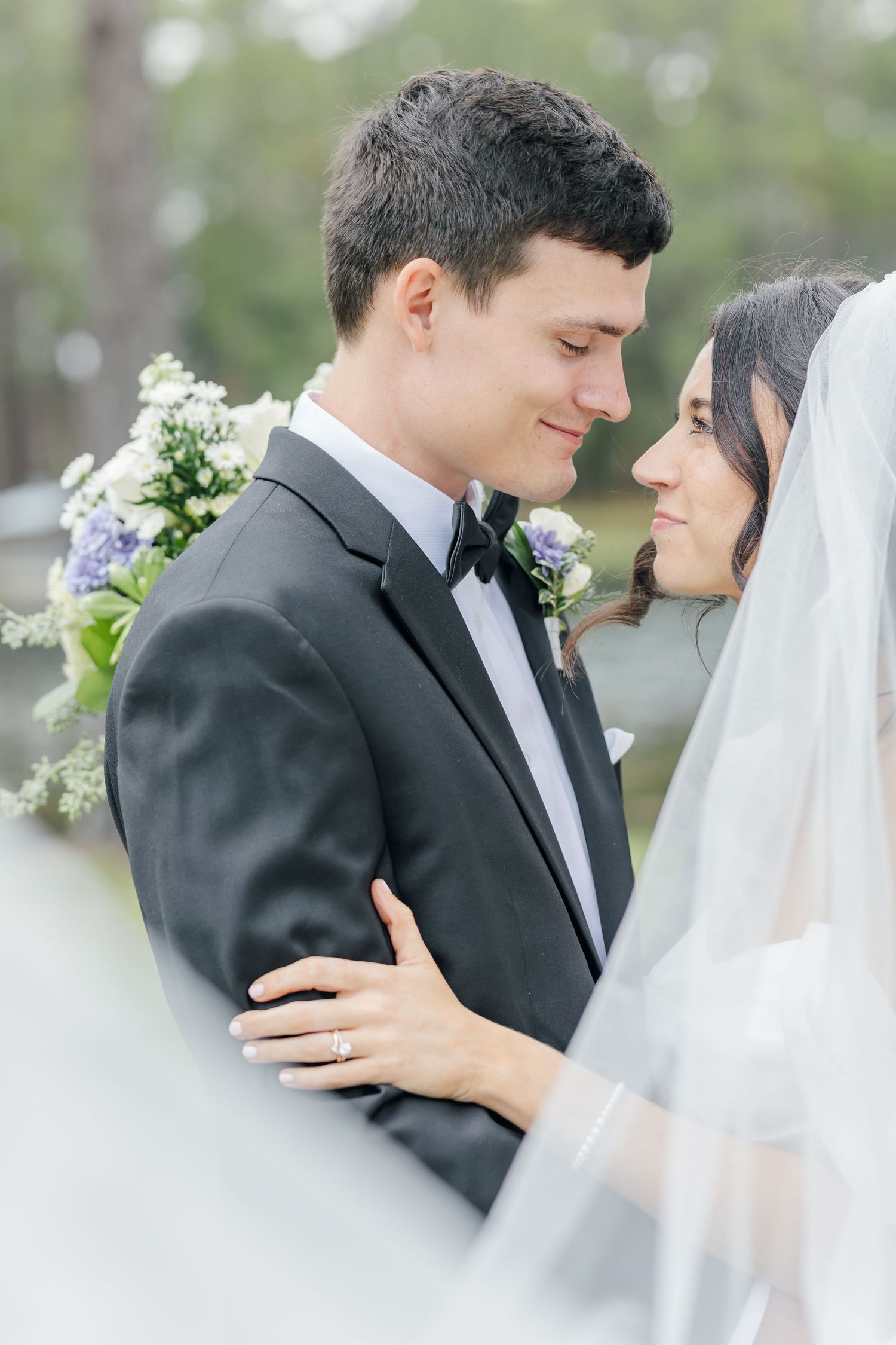 Romantic wedding portraits in soft focus showing tender moments between bride and groom outdoors.