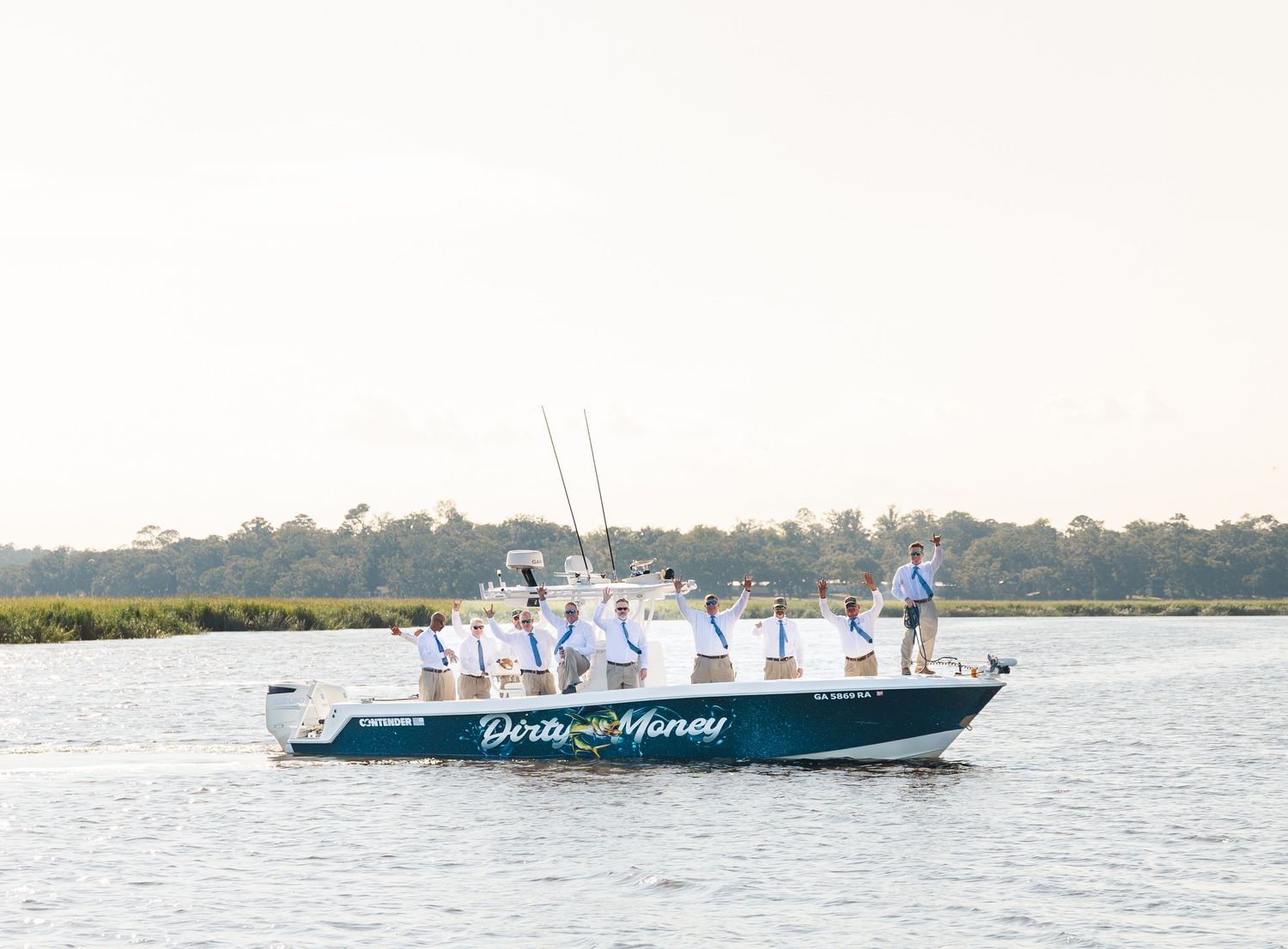 Multiple boats sailing across calm waters with coastal scenery in the background.